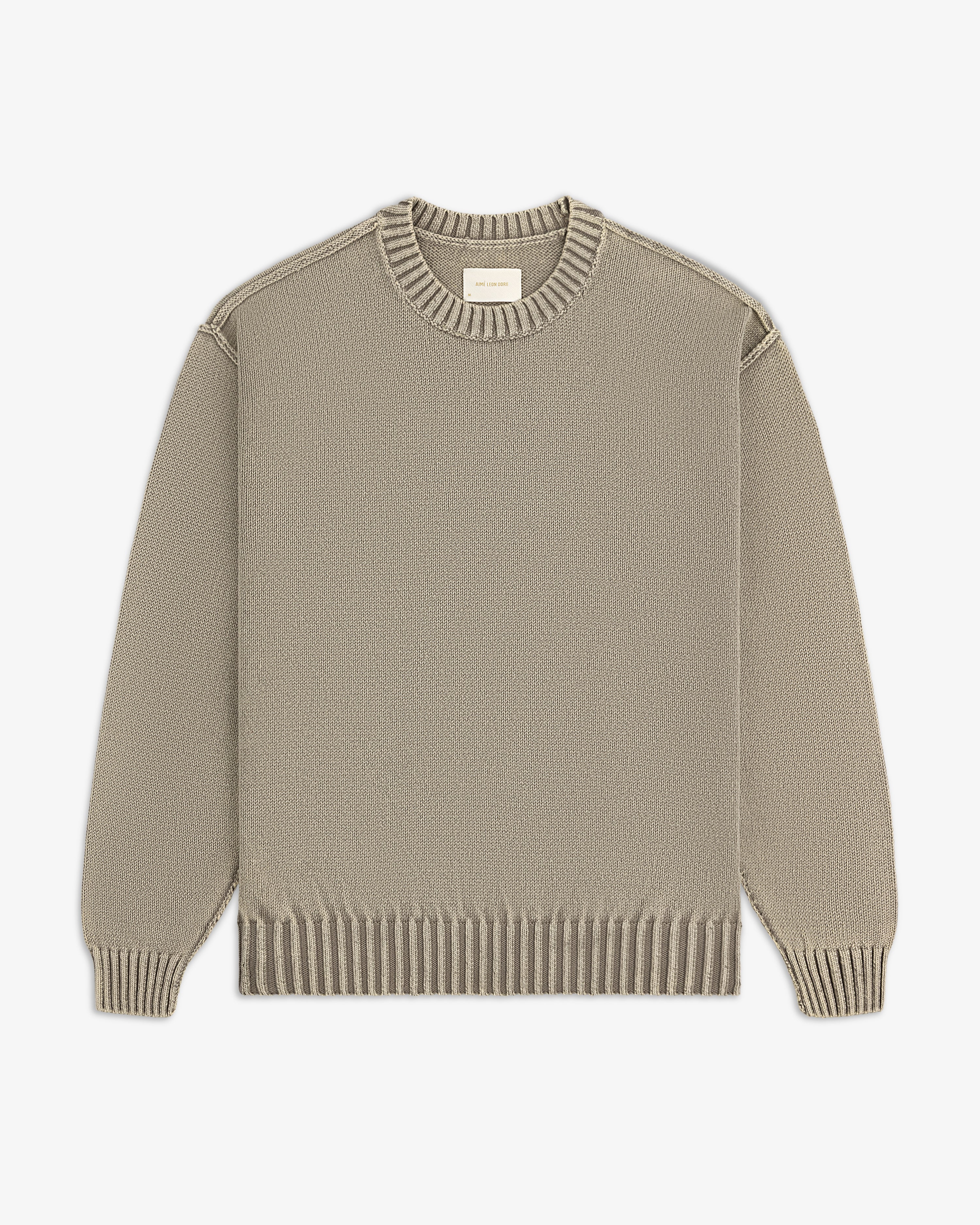 Washed Inside Out Sweater in beige with ribbed collar, cuffs, and hem, laid flat on a white background.