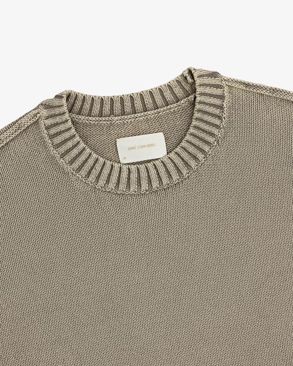 Washed Inside Out Sweater: Beige knit crewneck with ribbed collar and a white label at the neckline.