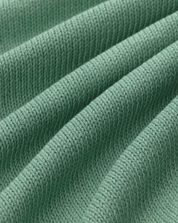 Close-up of the Washed Inside Out Sweater's green ribbed knit with textured, diagonal raised ridges.