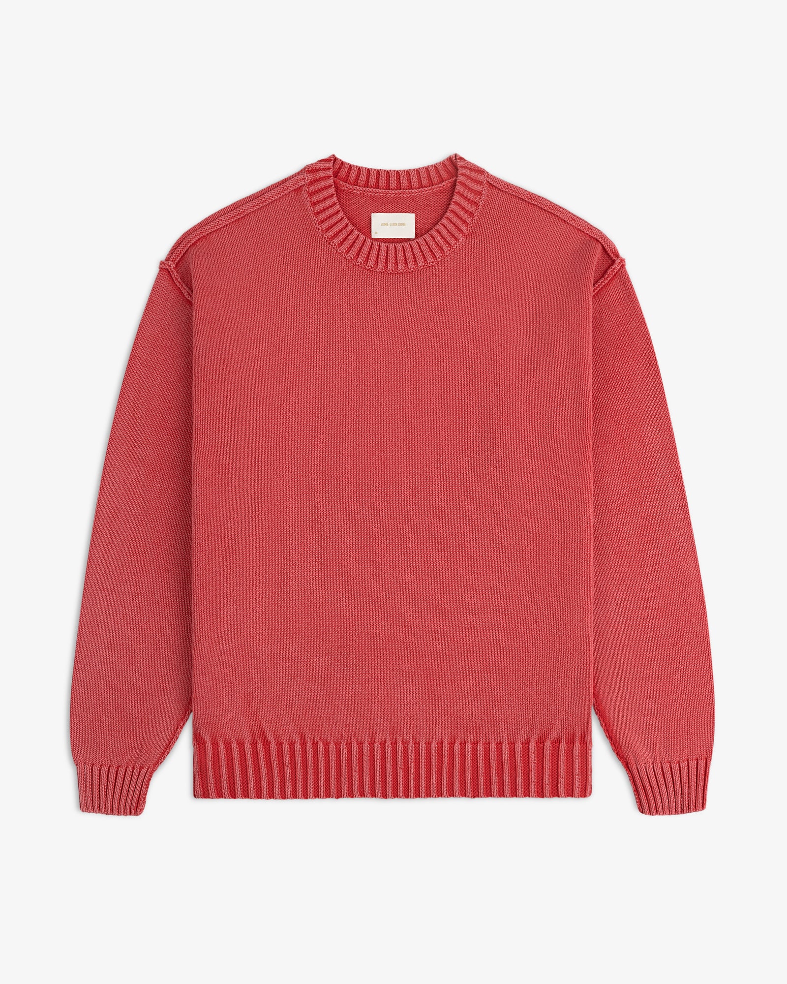 A Washed Inside Out Sweater with long sleeves and crew neck in red, laid flat on a white background.