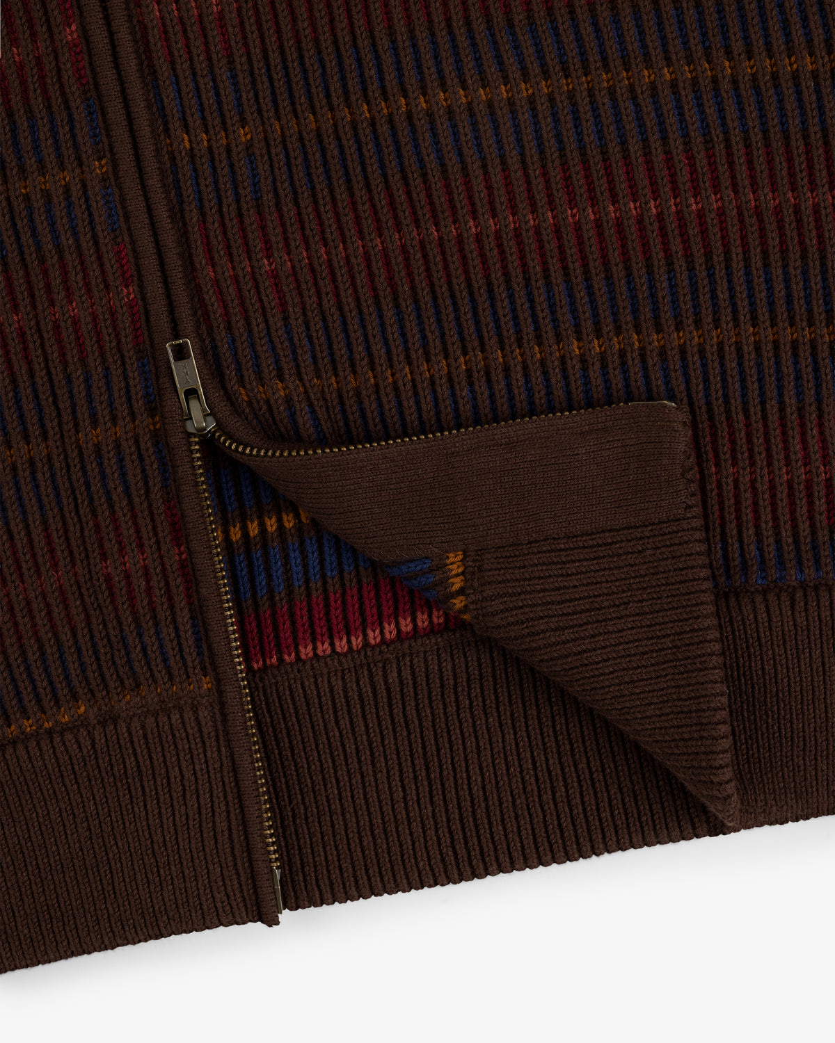 Close-up of the Multi Color Knit Track Sweater: brown ribbed knit with a gold zipper and red, blue, orange stripes.