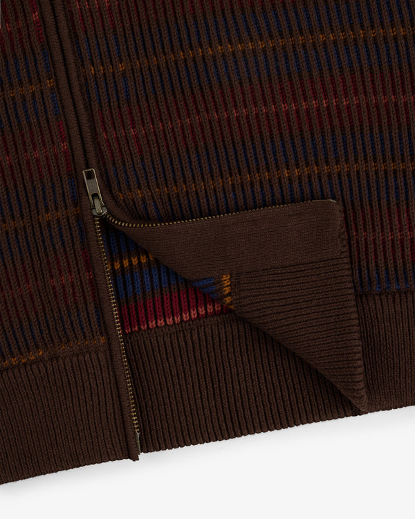 Close-up of the Multi Color Knit Track Sweater: brown ribbed knit with a gold zipper and red, blue, orange stripes.