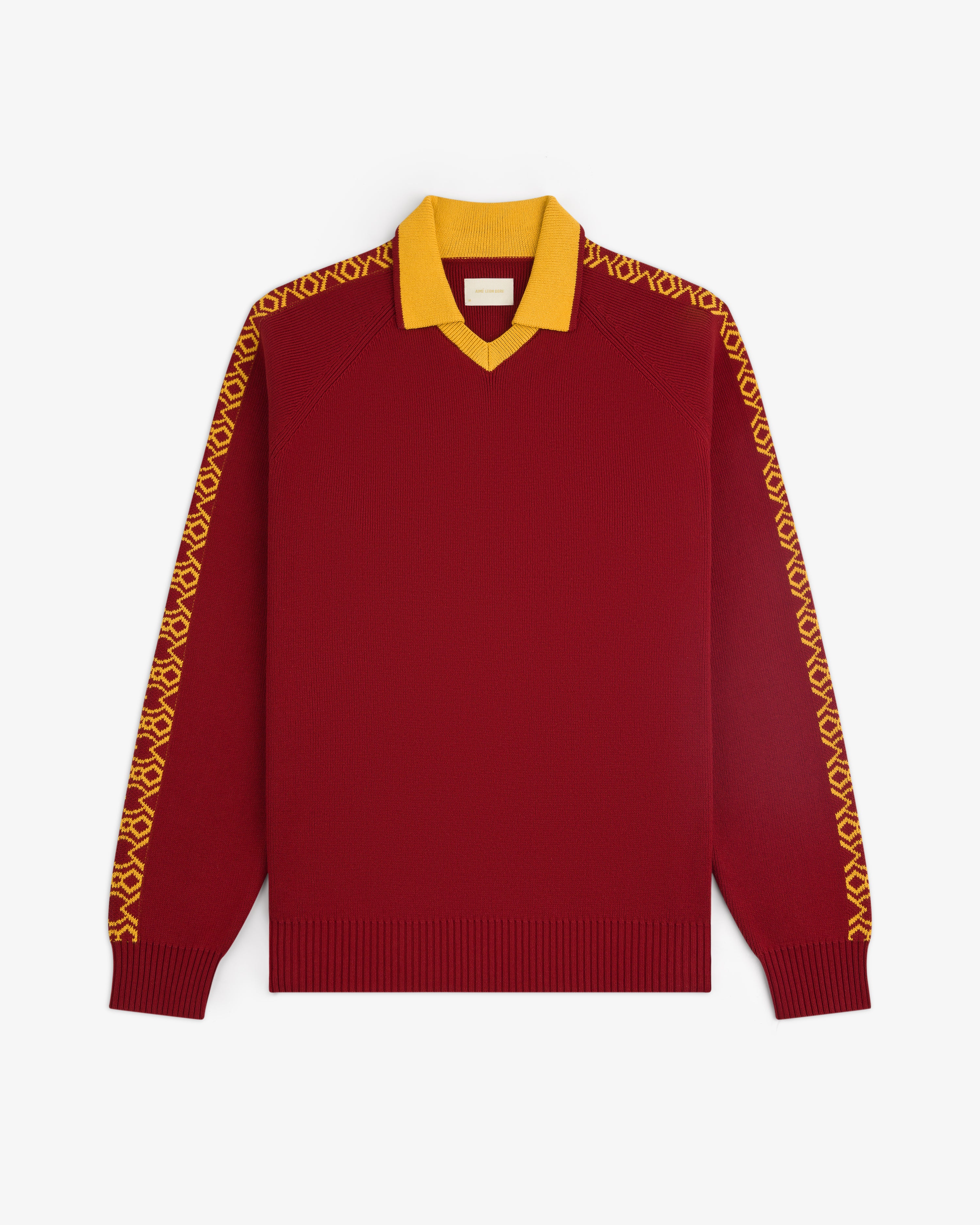 The Knit Sport Pullover is a maroon long-sleeve sweater with a yellow collar and yellow striped sleeves.