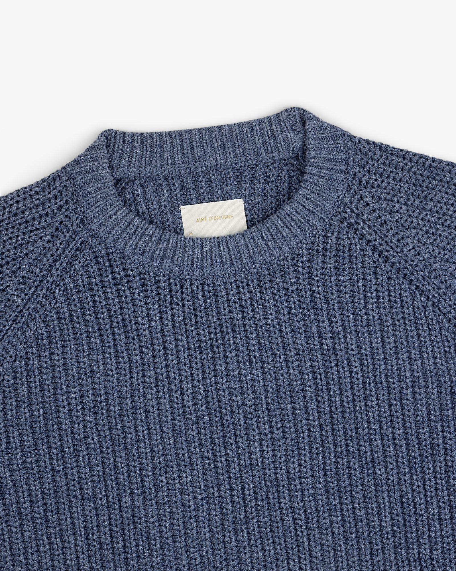 Knit Denim Crewneck Sweater shown from above on a white background.
