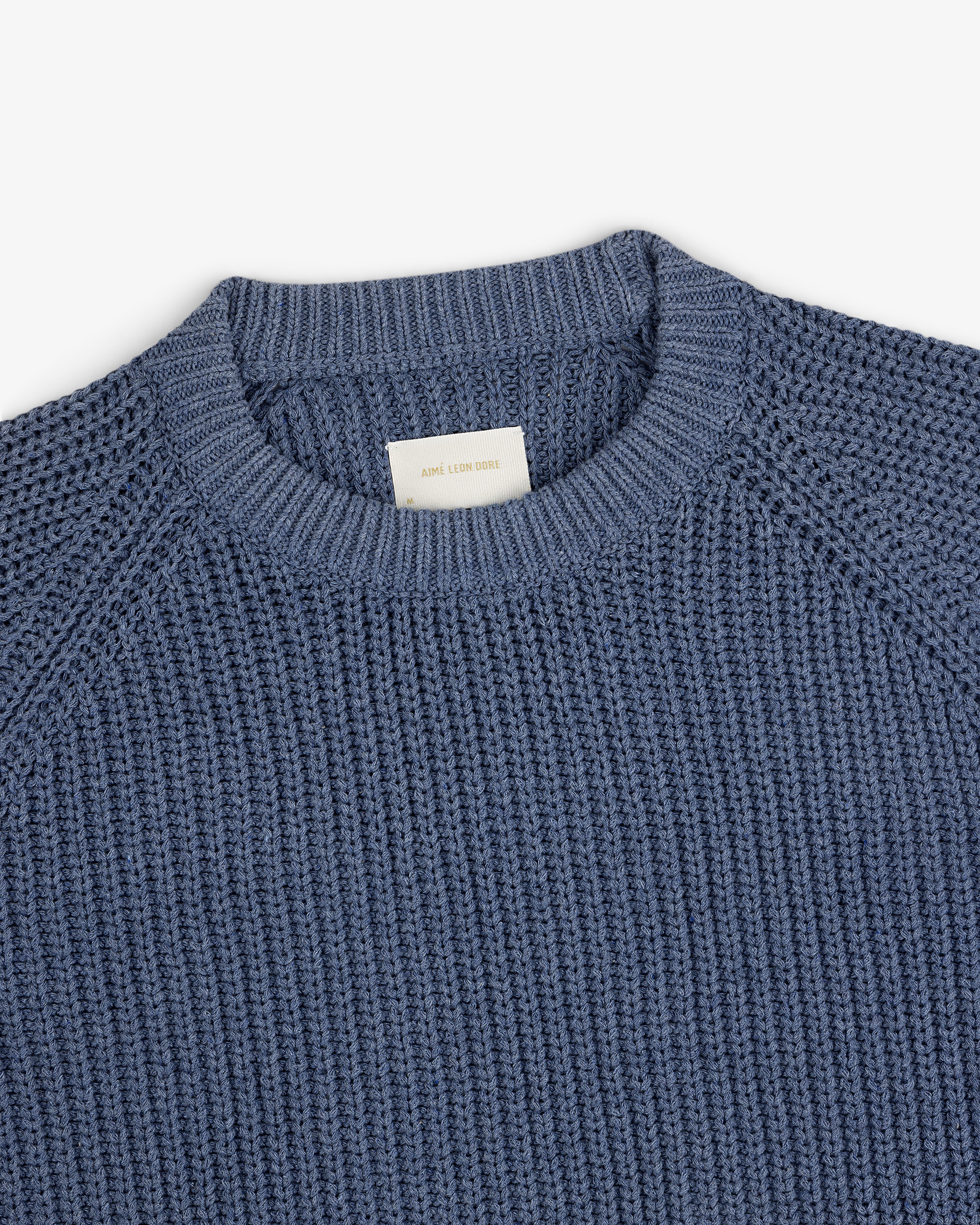 Knit Denim Crewneck Sweater shown from above on a white background.