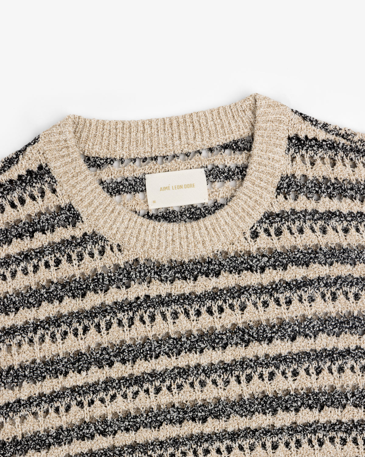 Bouclé Open Knit Crewneck Sweater by Aimé Leon Dore in beige and black stripes with a ribbed collar.