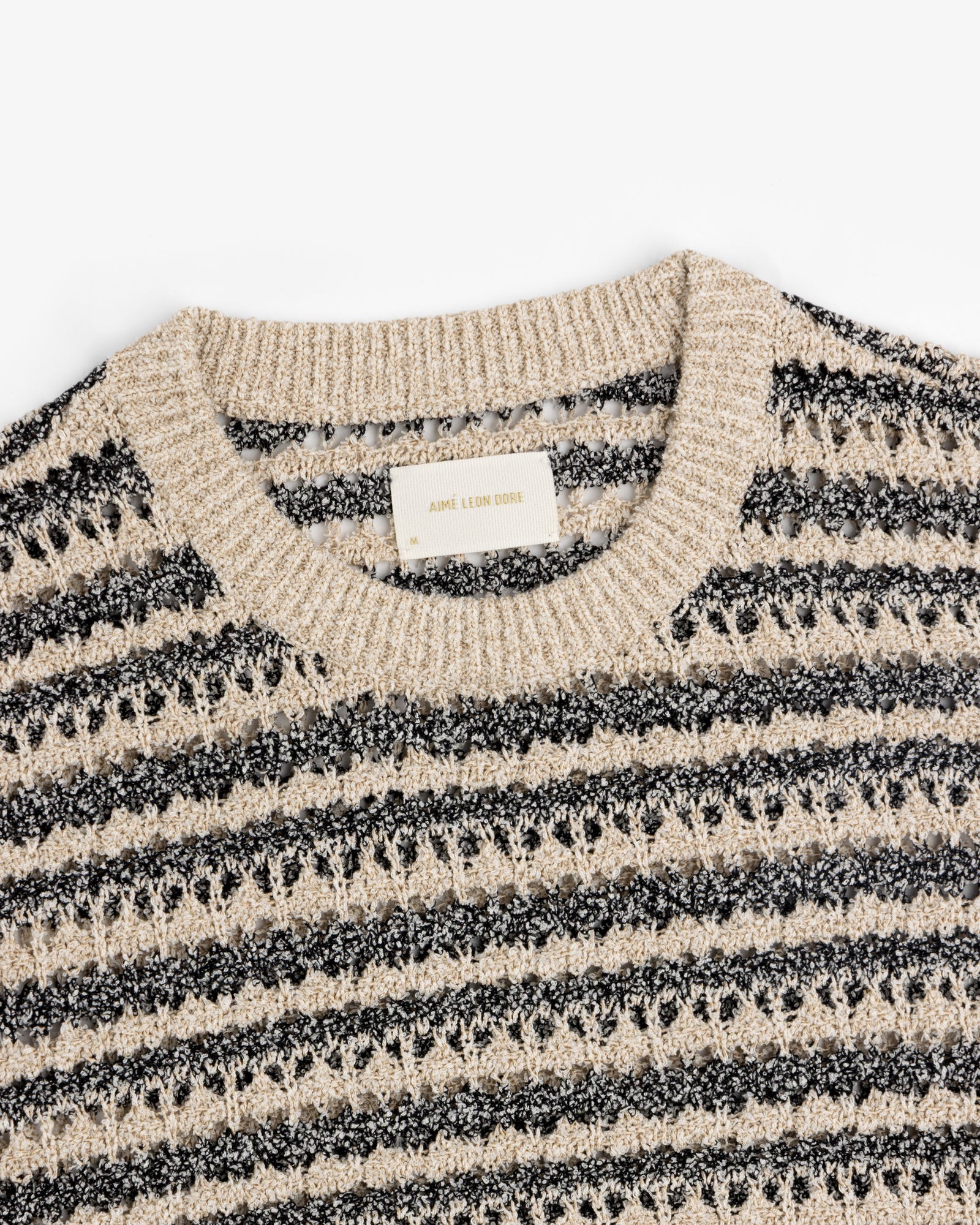 Bouclé Open Knit Crewneck Sweater by Aimé Leon Dore in beige and black stripes with a ribbed collar.