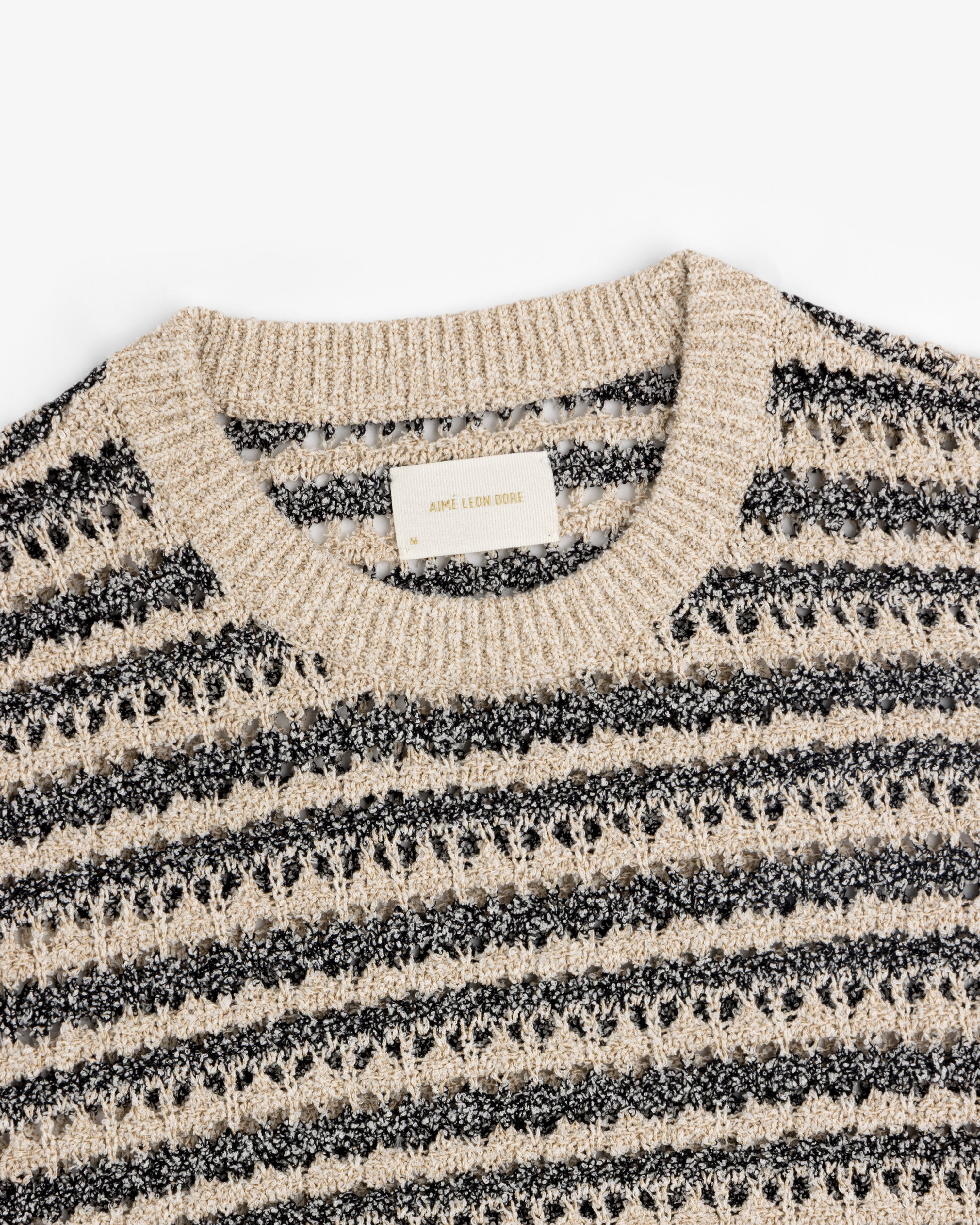 Bouclé Open Knit Crewneck Sweater by Aimé Leon Dore in beige and black stripes with a ribbed collar.