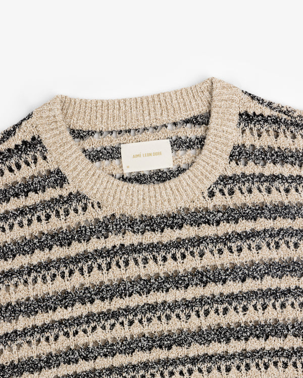 Bouclé Open Knit Crewneck Sweater by Aimé Leon Dore in beige and black stripes with a ribbed collar.