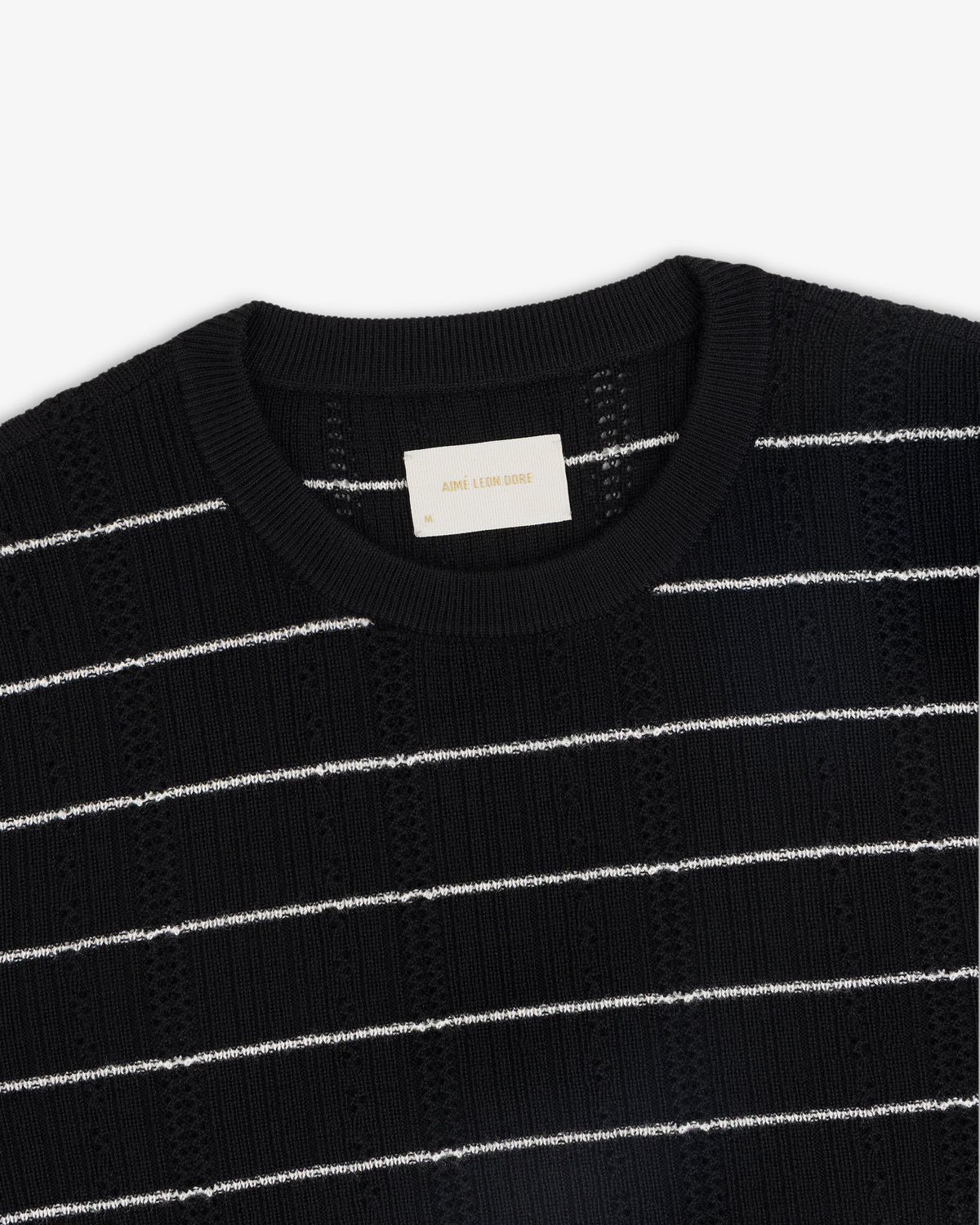 Merino Wool Eyelet Tee with white horizontal stripes and a ribbed crew neckline, shown from above.