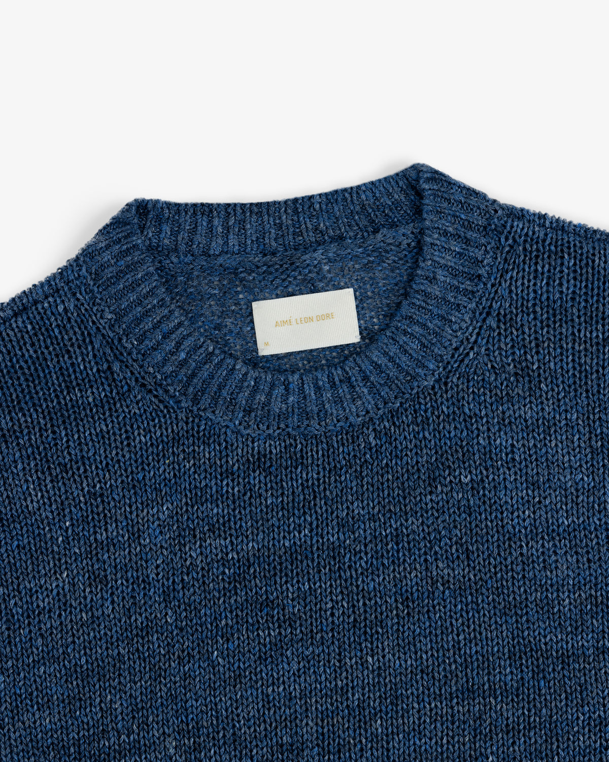 Linen Knit Crewneck Sweater in blue with a white Aime Leon Dore label inside collar, shown on a white background.