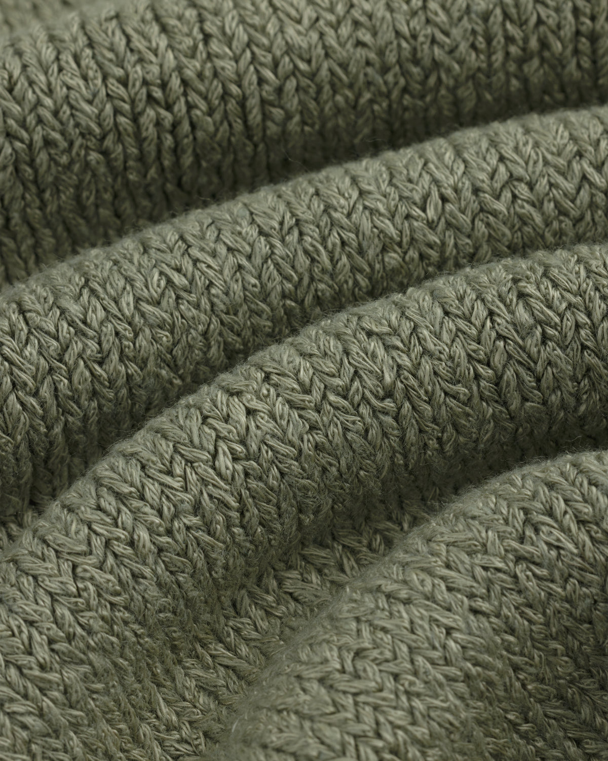 Close-up of Linen Knit Drawstring Short in olive green with visible textured stitches and curved folds.