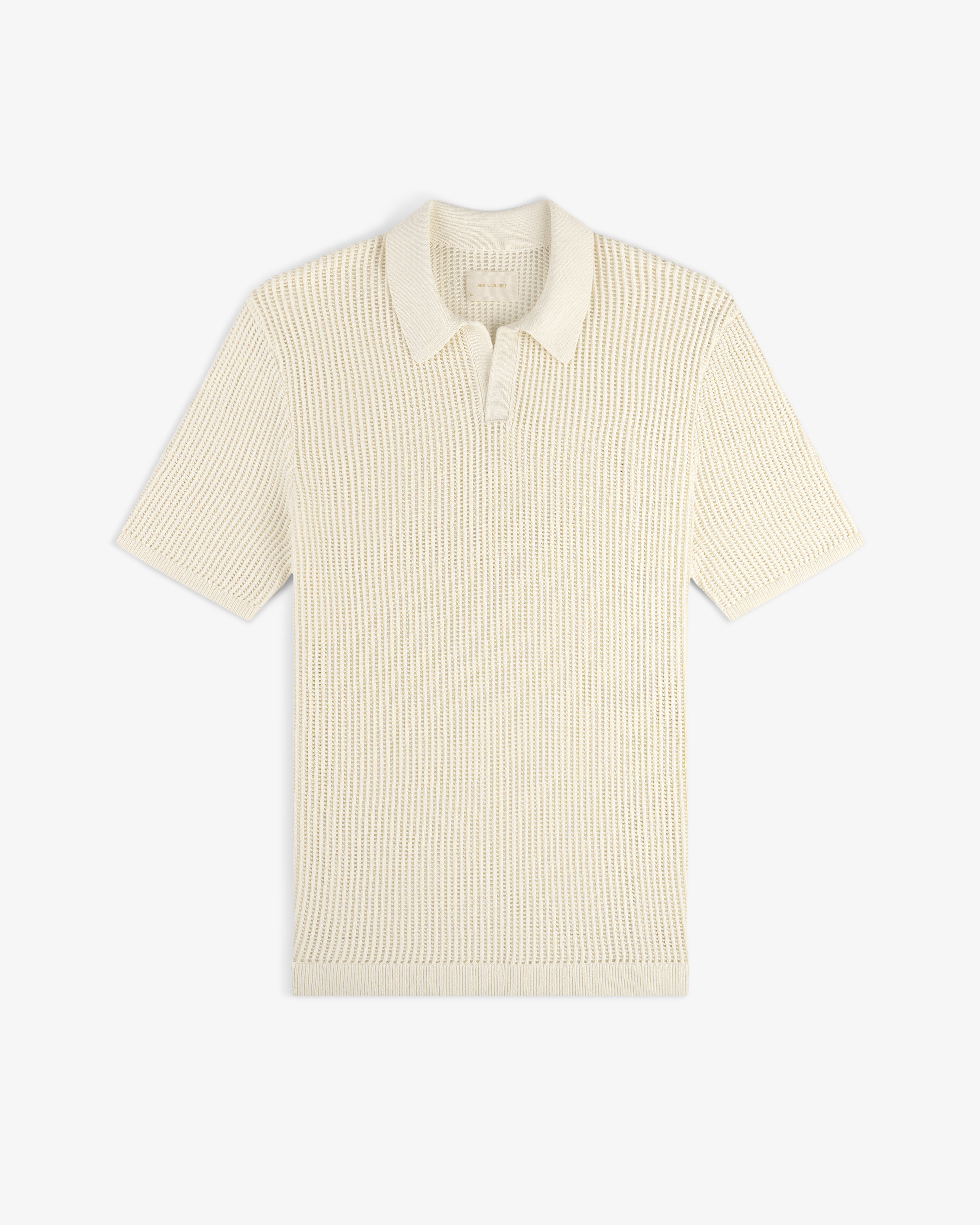 Cream-colored Mesh Knit Polo with short sleeves, textured pattern, and collar, laid flat on a white background.