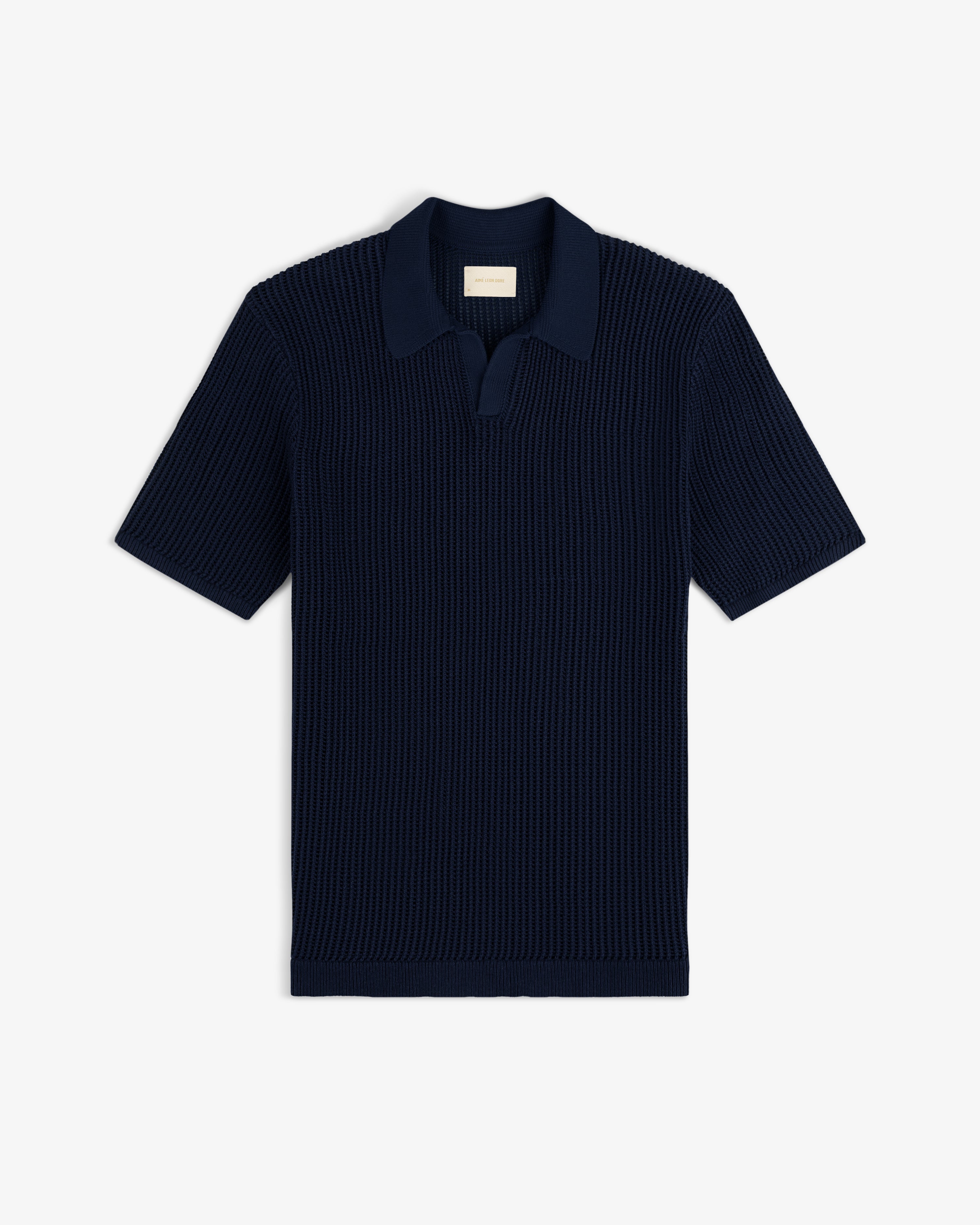 Mesh Knit Polo in navy blue with short sleeves, ribbed texture, and open collar, shown flat on a white background.