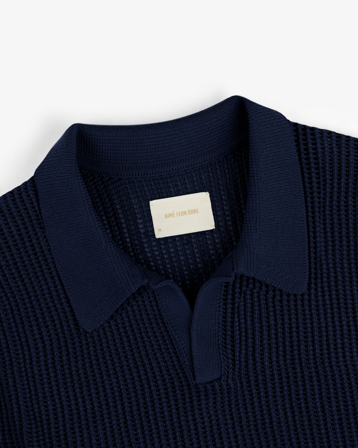 Navy Mesh Knit Polo with a visible label inside the collar.