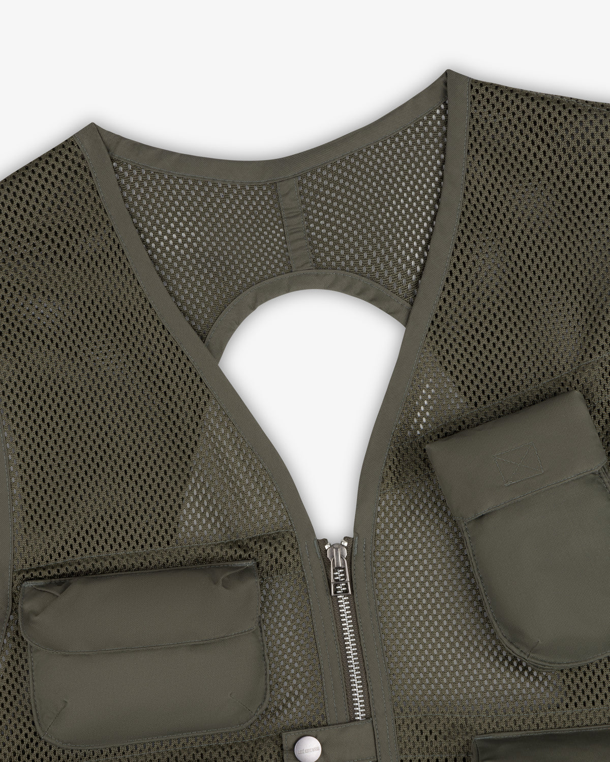 Close-up of the Nylon Utility Vest in green mesh with zipper, pockets, and a circular cutout on the back.