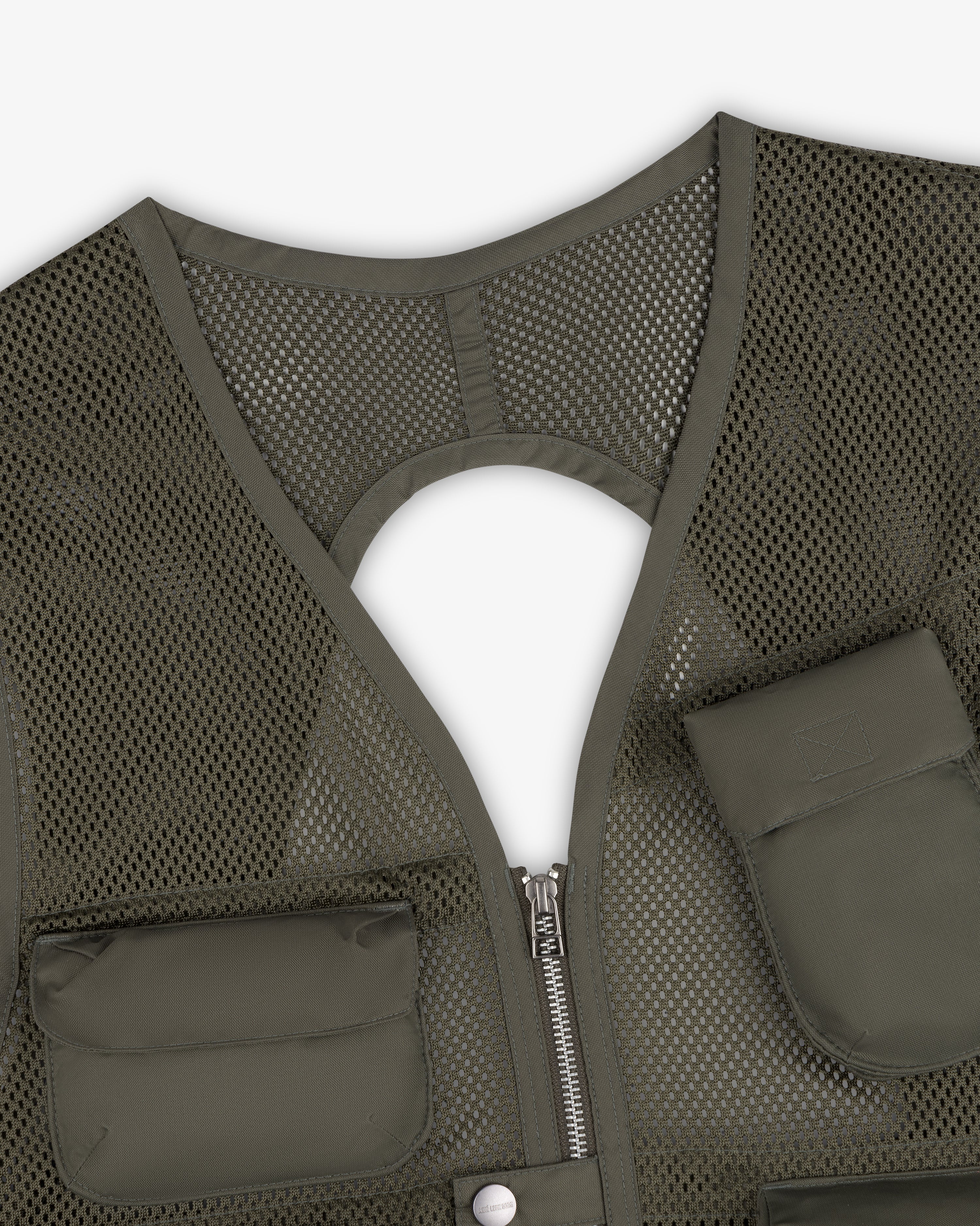 Close-up of the Nylon Utility Vest in green mesh with zipper, pockets, and a circular cutout on the back.