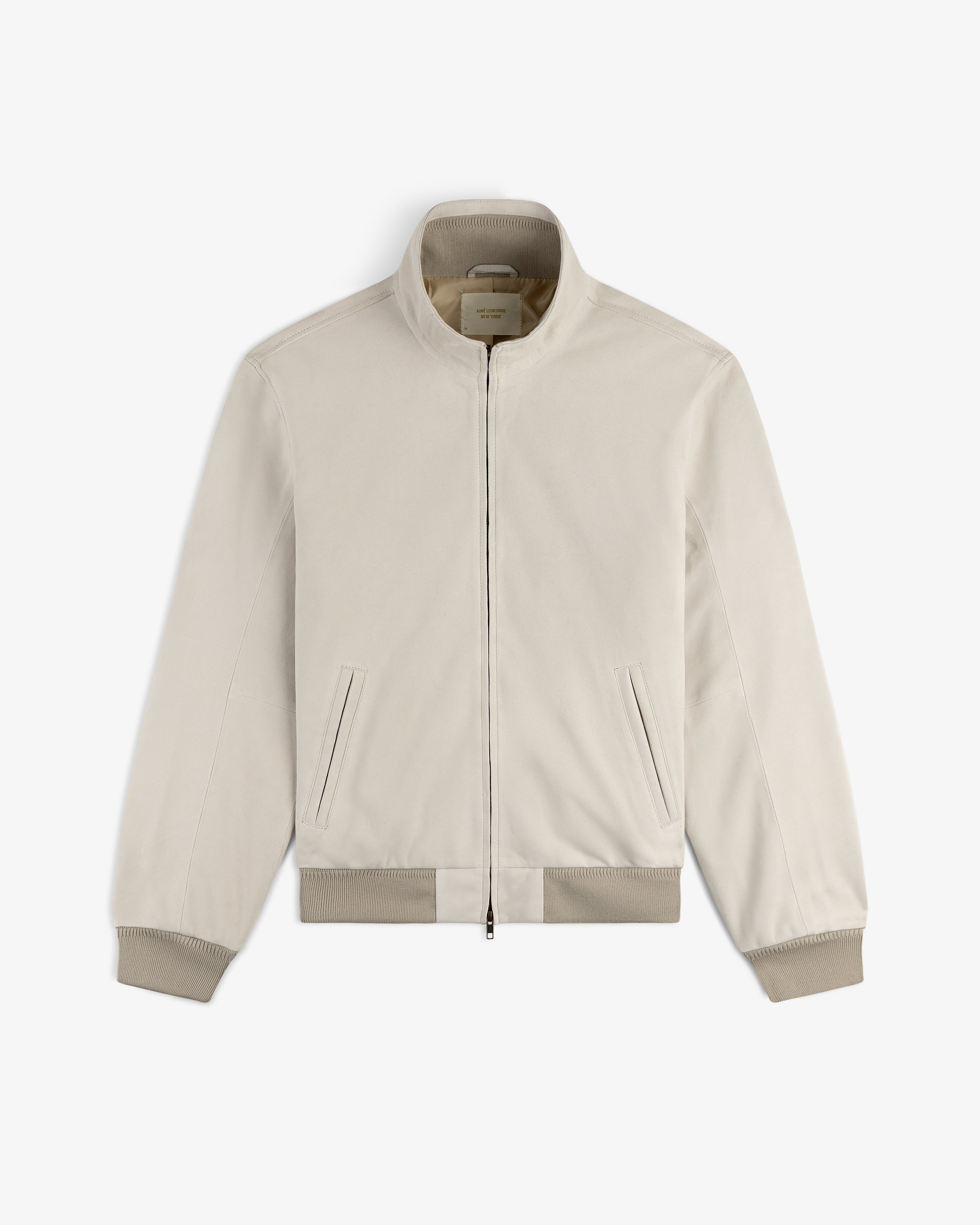 Suede Track Jacket in light beige with zip-up front, stand collar, ribbed cuffs, and side pockets, displayed flat.