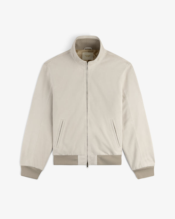 Suede Track Jacket in light beige with zip-up front, stand collar, ribbed cuffs, and side pockets, displayed flat.
