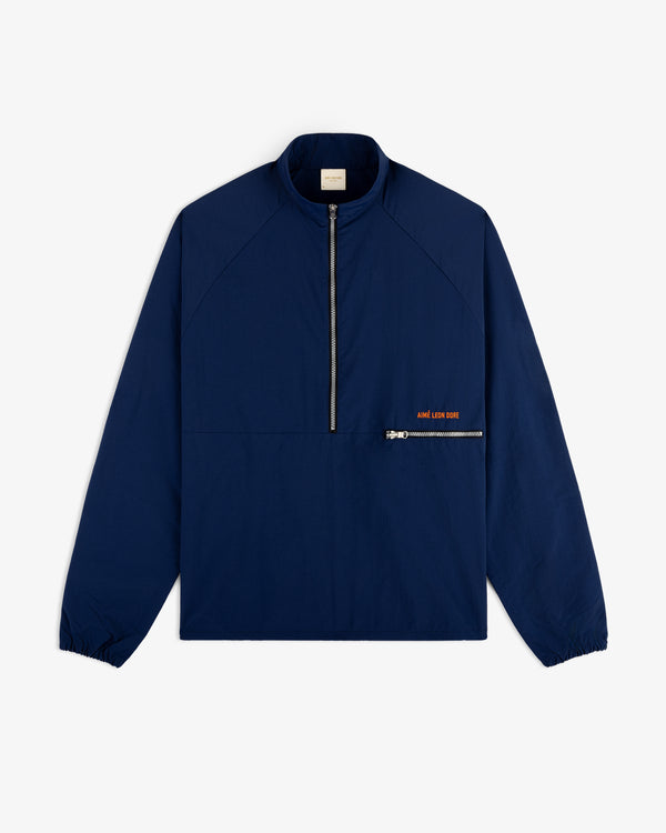 Nylon Packable Windbreaker in navy blue with half-zip front, diagonal pocket, and subtle orange text.