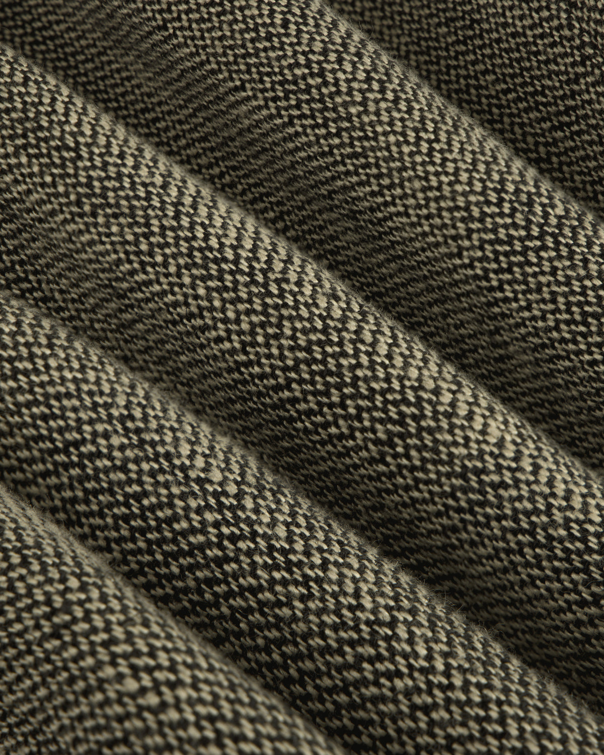 Close-up of the Single-Breasted Yarn Dyed Linen Suit Jacket's ribbed, textured woven fabric with raised and flat sections.