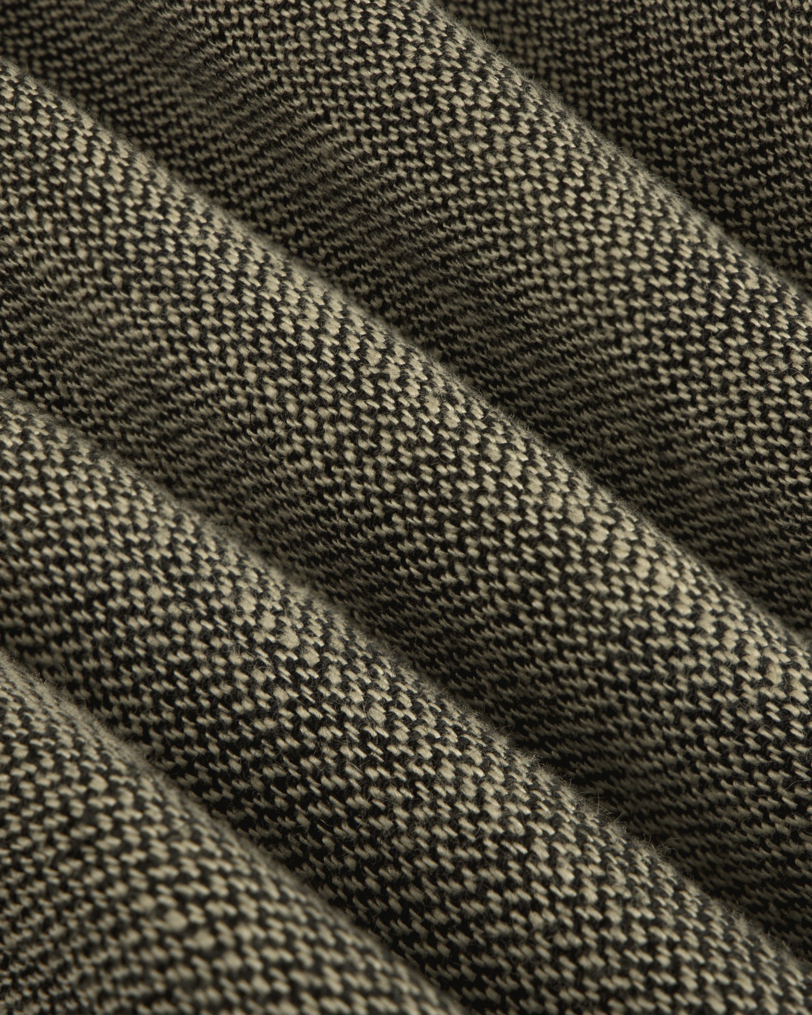 Close-up of the Single-Breasted Yarn Dyed Linen Suit Jacket's ribbed, textured woven fabric with raised and flat sections.