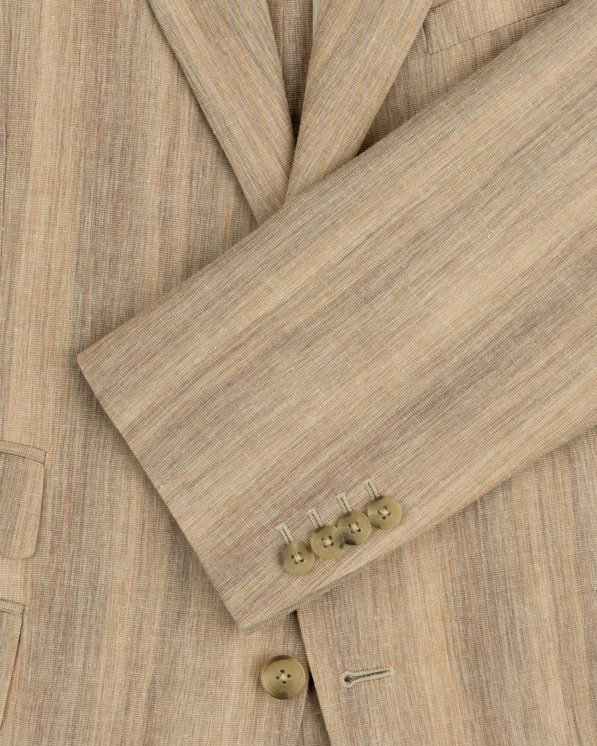 Close-up of a Single-Breasted Safari Suit Jacket sleeve in beige with four brown buttons and part of the pocket visible.