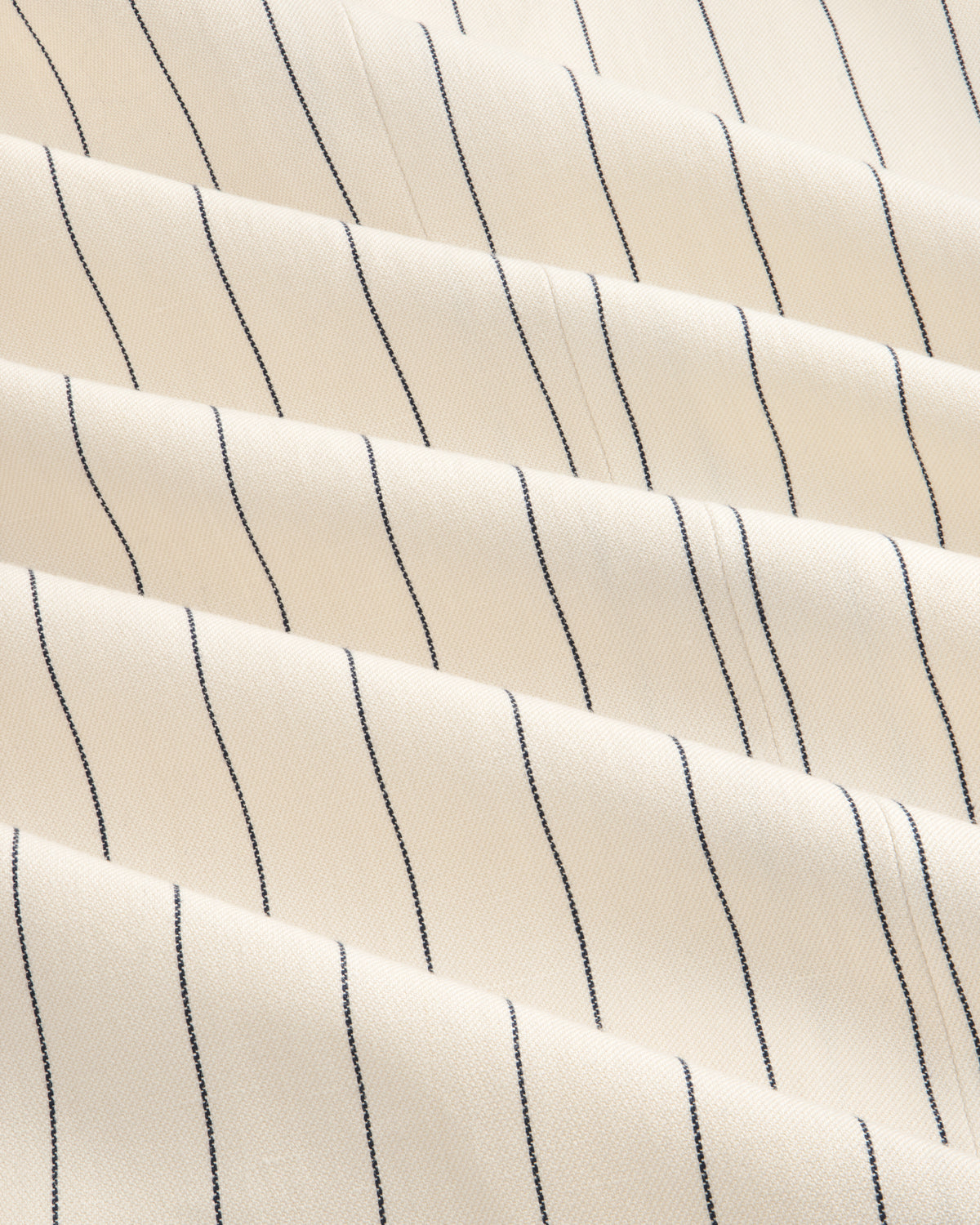 Cream-colored Double-Breasted Pinstripe Suit Jacket with thin black stripes and a subtly textured surface.
