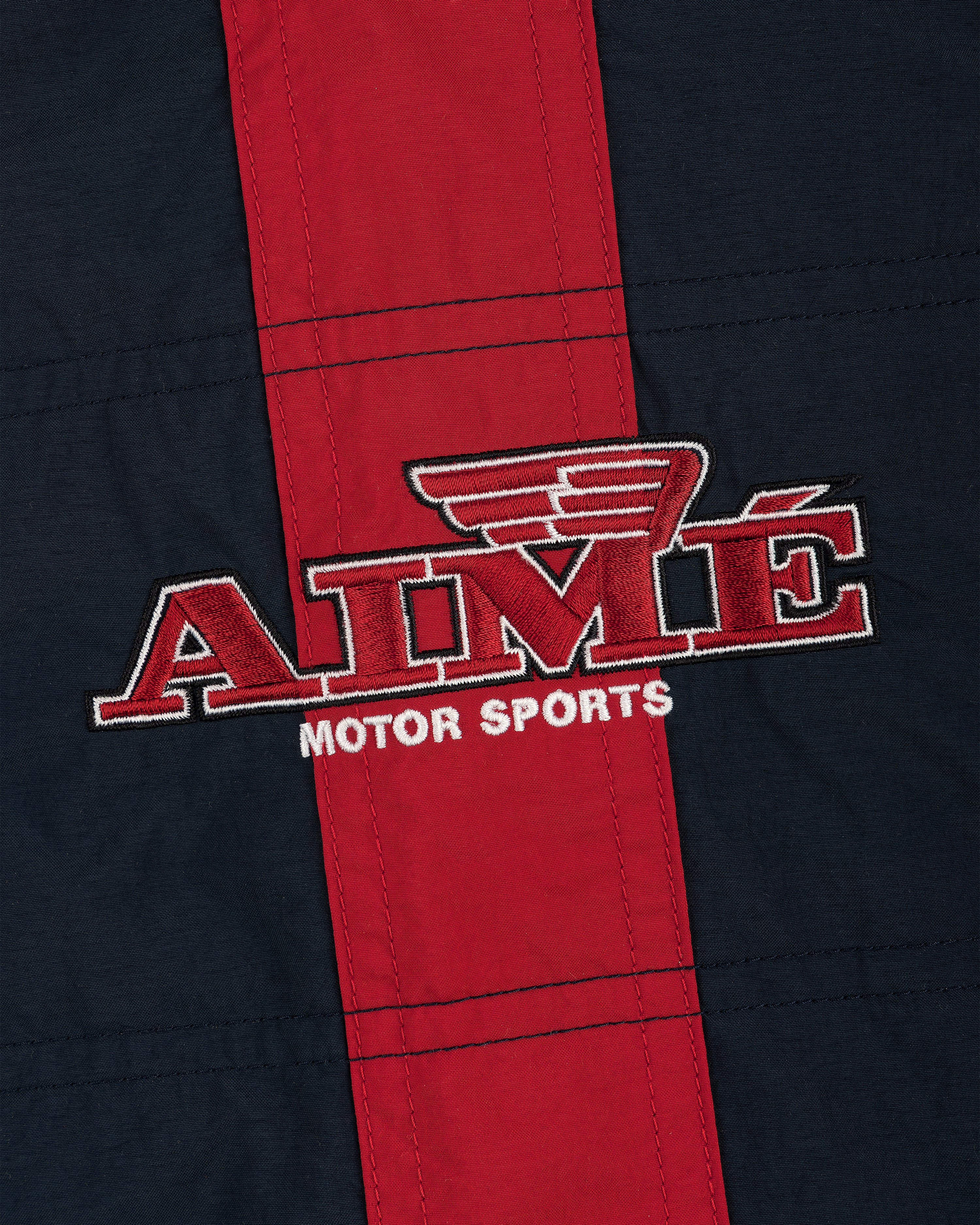 Nylon Moto Jacket in red and navy with AIMÉ MOTOR SPORTS logo and wing design above the letter M.