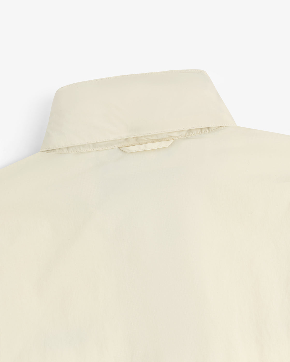 Close-up of the back of a Nylon Track Jacket, showing the collar and a small fabric loop below it.