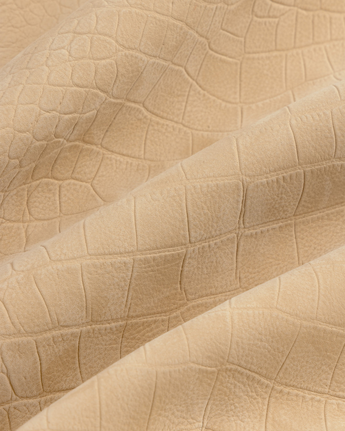 Croc-Embossed Nubuck Bomber Jacket in beige features a crocodile texture and subtle folds.