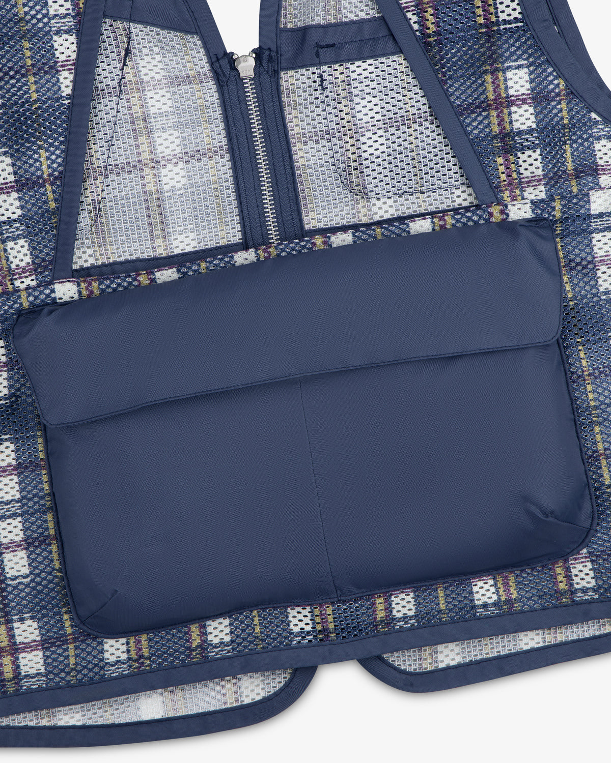 The Nylon Madras Utility Vest features a navy padded pocket, mesh and plaid fabric, a zipper, and blue trim.