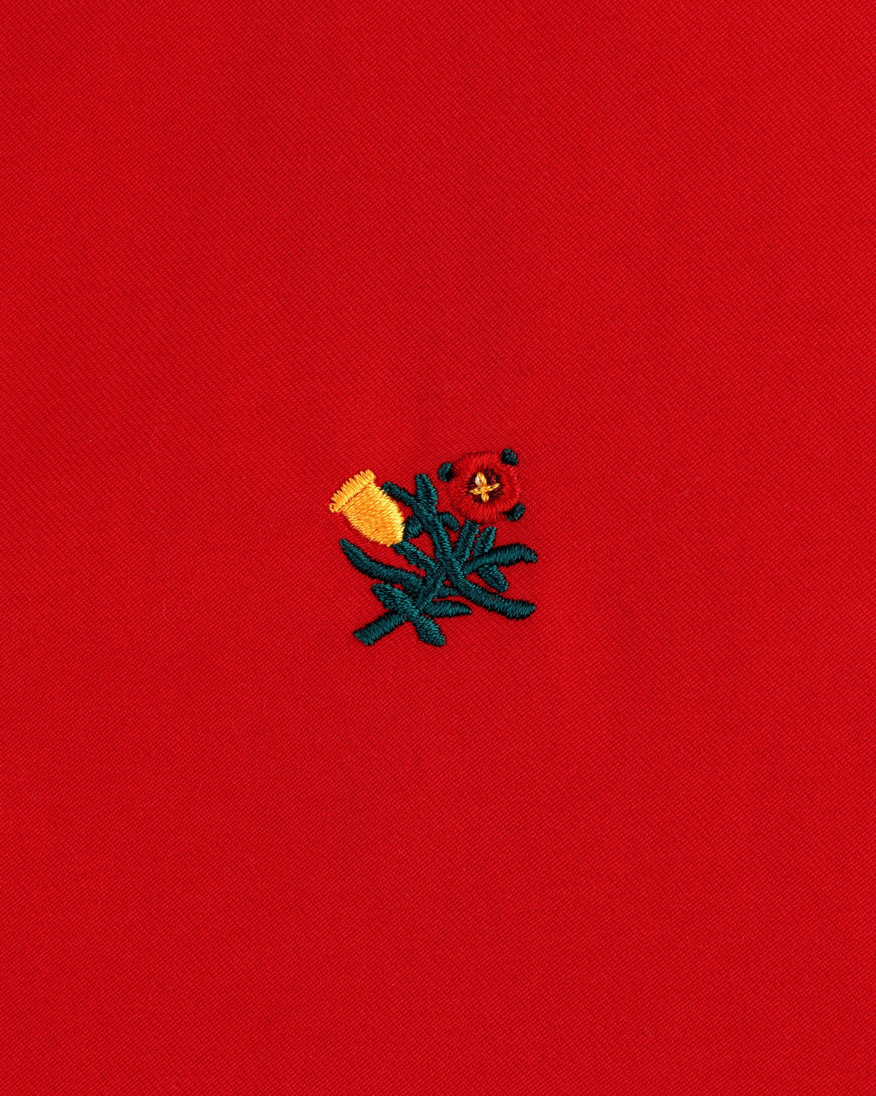 Small yellow and red embroidered flowers with green stems adorn the Crest Casual Jacket’s bright red fabric.