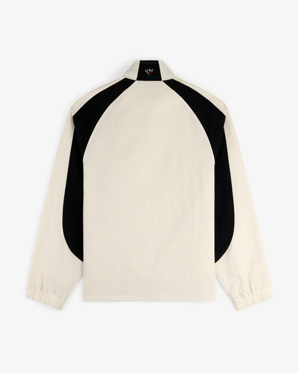 Crest Nylon Half-Zip Pullover in beige with black curved back panels and elastic cuffs, shown on white background.