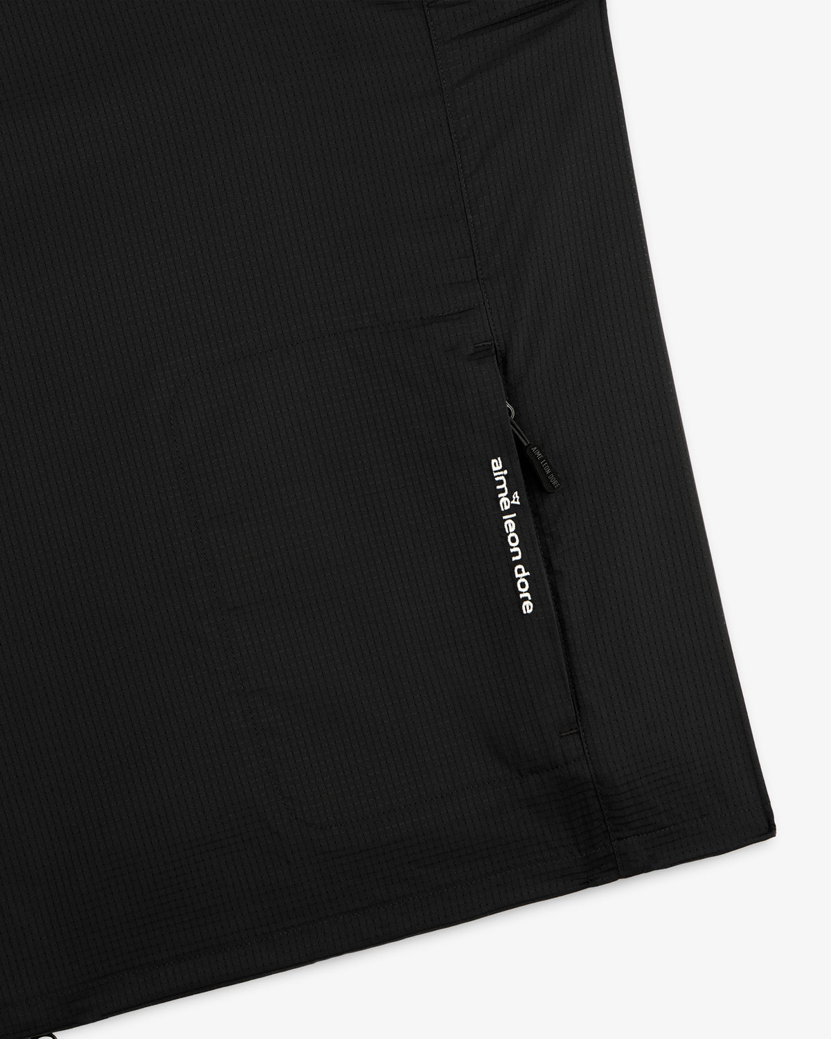 Close-up of the ALD Golf Lightweight Tips Windbreaker, featuring a zip pocket and white Aimé Leon Dore logo.