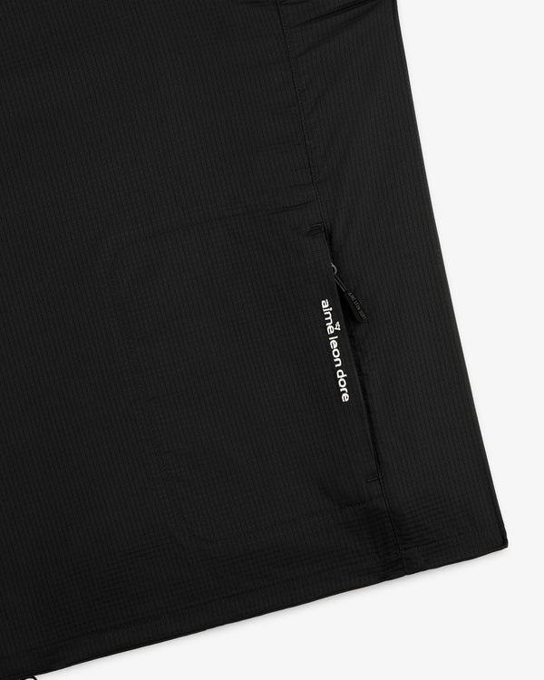 Close-up of the ALD Golf Lightweight Tips Windbreaker, featuring a zip pocket and white Aimé Leon Dore logo.