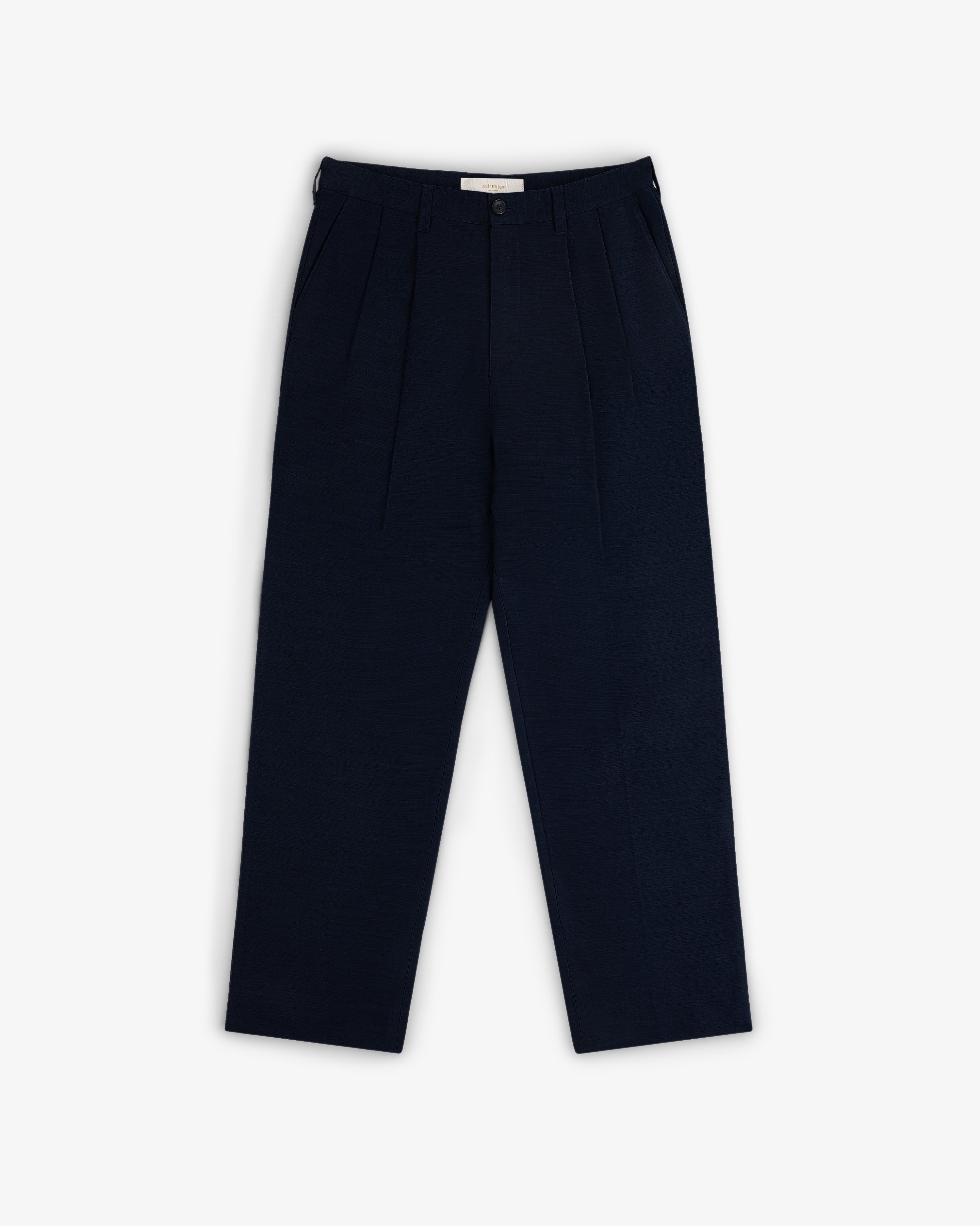 Double Pleated Pant in navy blue laid flat on a white background.