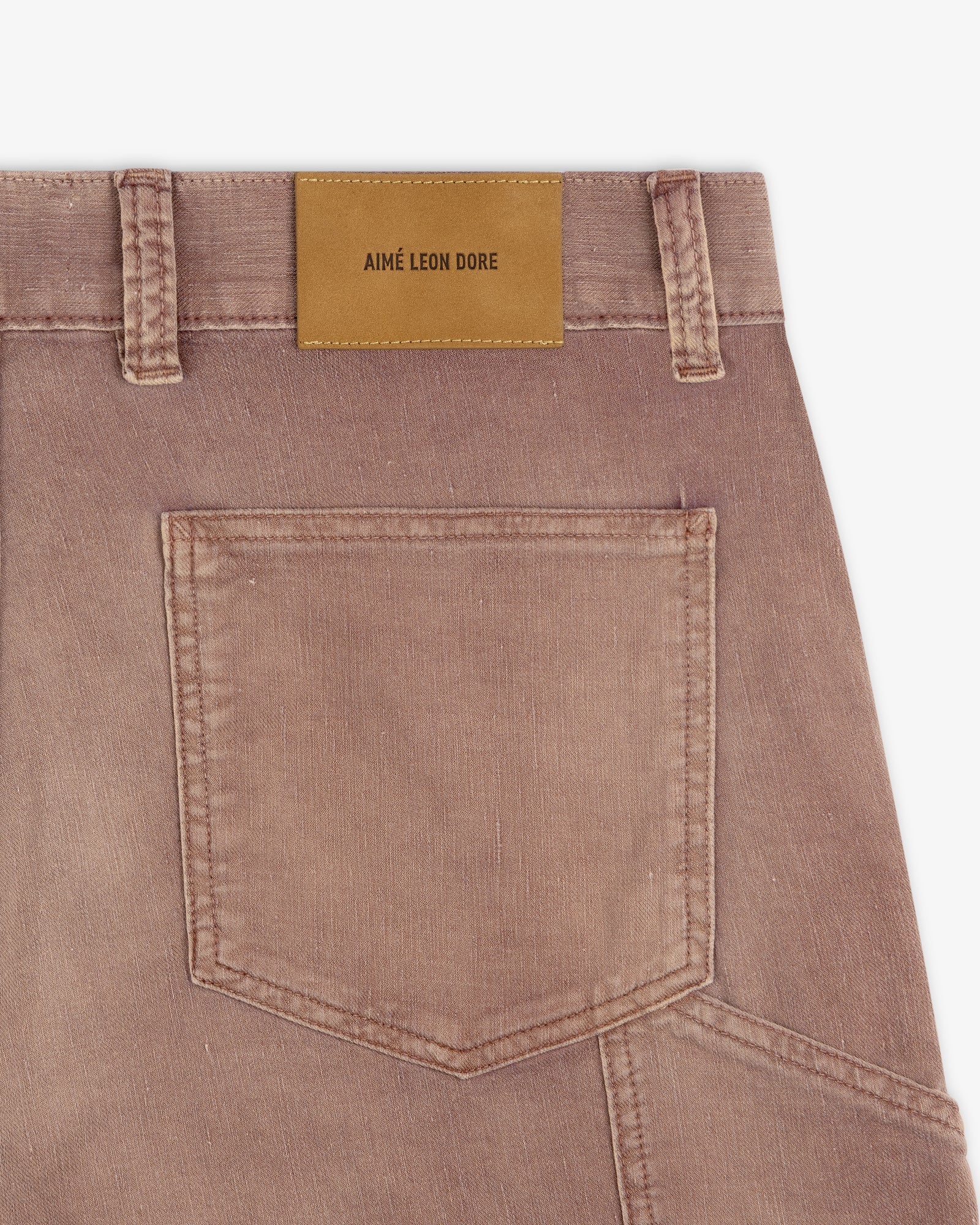 Close-up of Linen Blend Carpenter Pant’s brown back pocket with a tan leather "Aimé Leon Dore" label on the waistband.