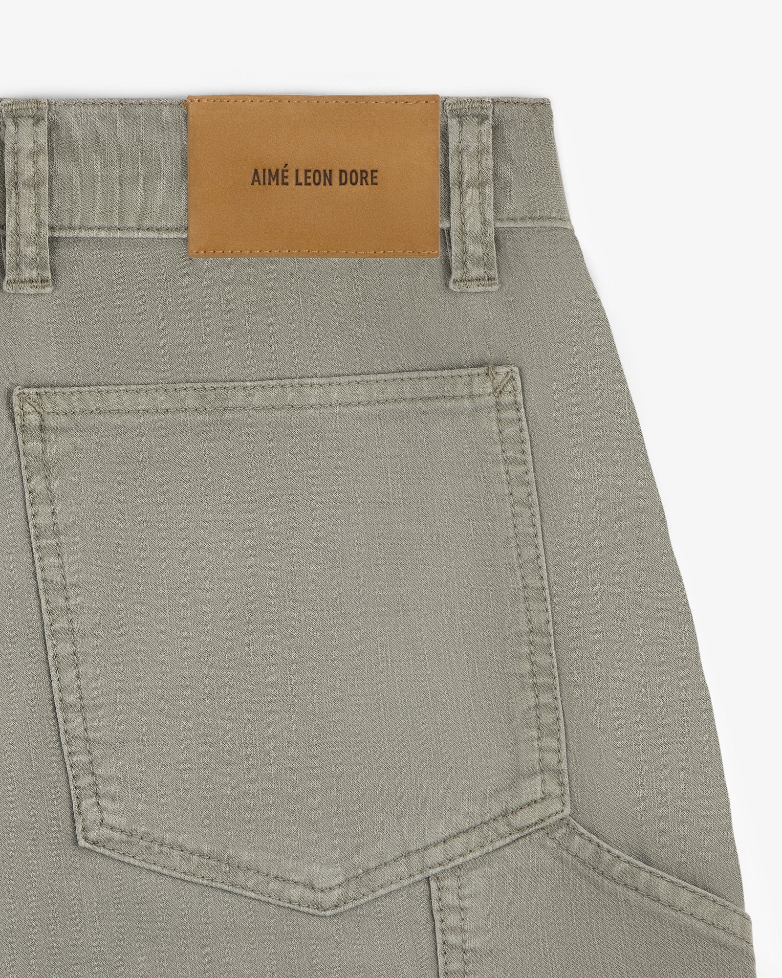 Close-up of Linen Blend Carpenter Pant featuring a large back pocket and a brown AIMÉ LEON DORE patch on the waistband.