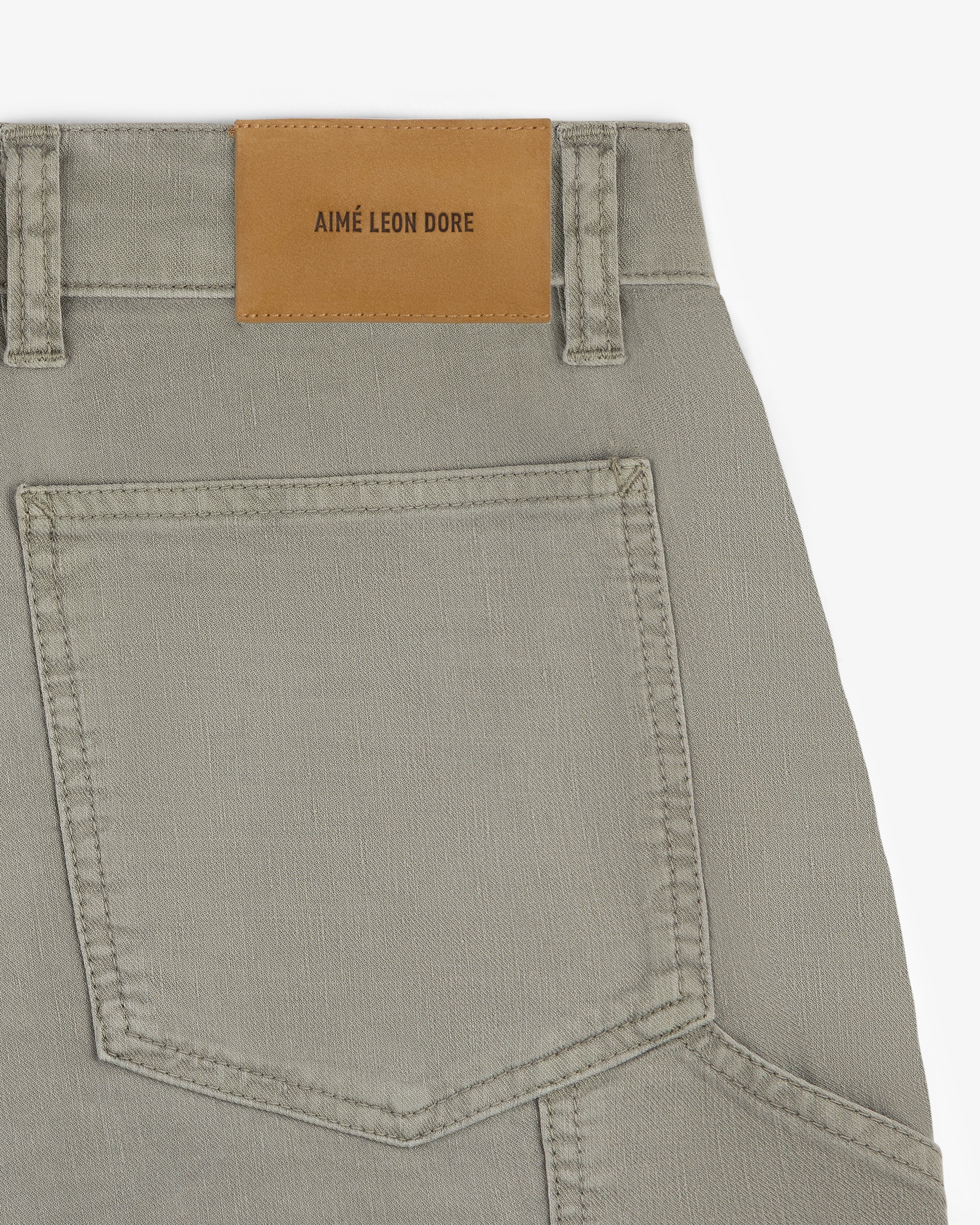 Close-up of Linen Blend Carpenter Pant featuring a large back pocket and a brown AIMÉ LEON DORE patch on the waistband.