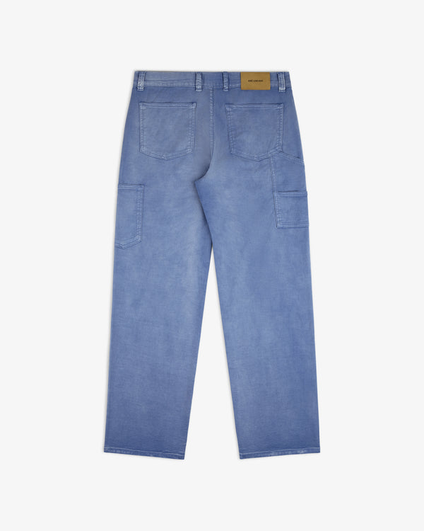 Linen Blend Carpenter Pant in light blue denim, shown from the back with large pockets and a tan label on the waistband.