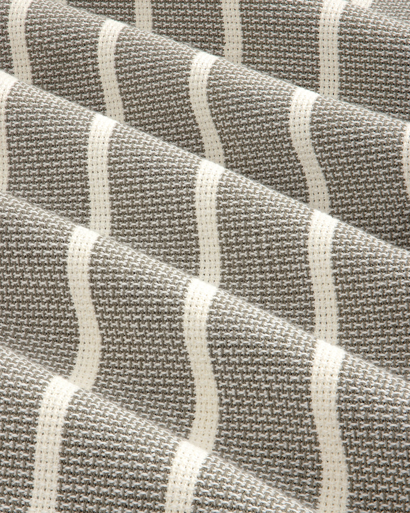 Close-up of Wide Leg Shore Pant in gray and white houndstooth with cream horizontal stripes and textured weave.