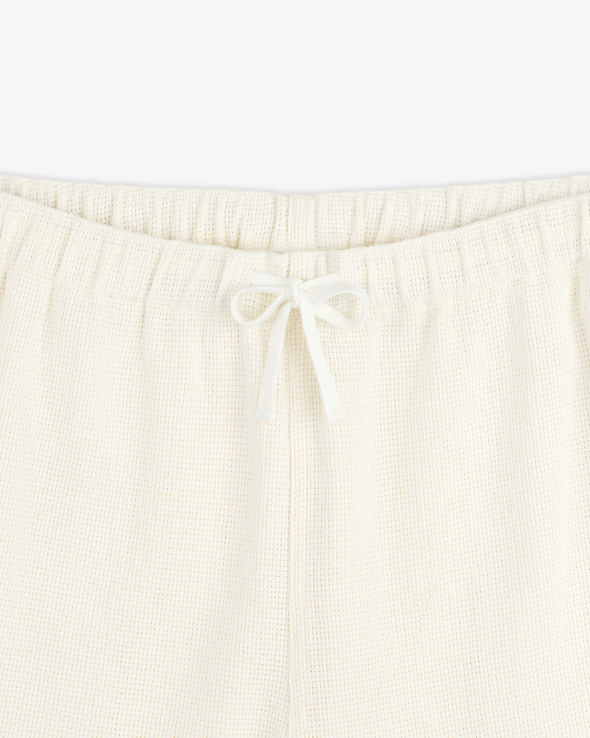 Close-up of Wide Leg Shore Pant in cream with elastic waistband and center-tied drawstring.
