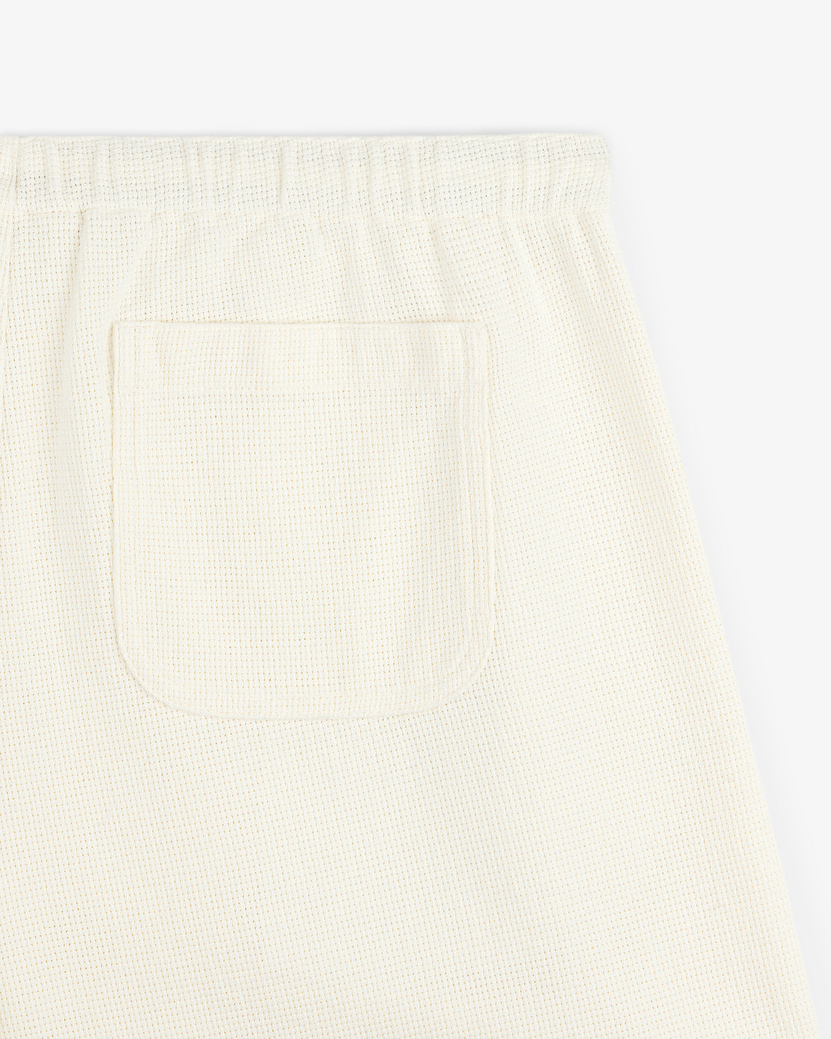 Close-up of Wide Leg Shore Pant in off-white textured fabric with elastic waistband and a back patch pocket.