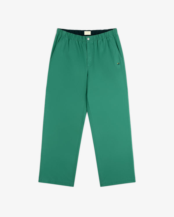Washed Cotton Windbreaker Pant in green with elastic waistband, side pockets, and relaxed fit on white background.