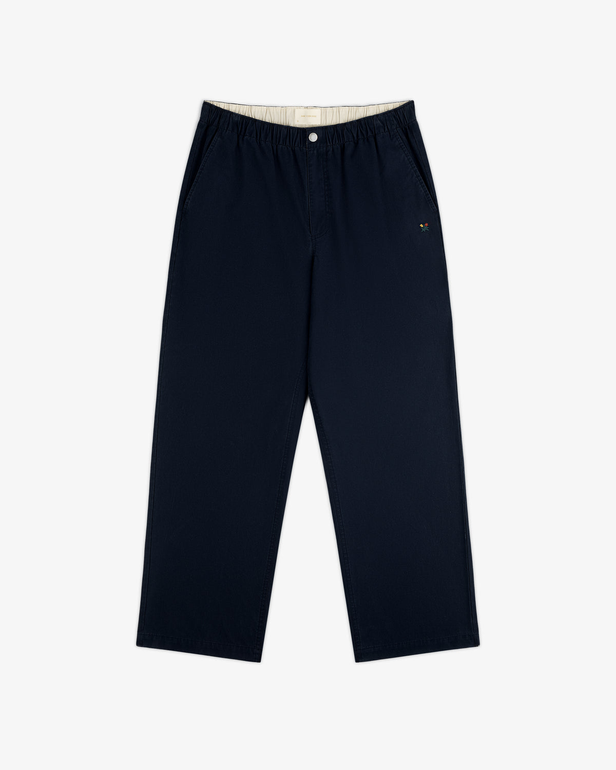 Washed Cotton Windbreaker Pant in navy blue features wide legs, elastic waistband, and small logo on left pocket.