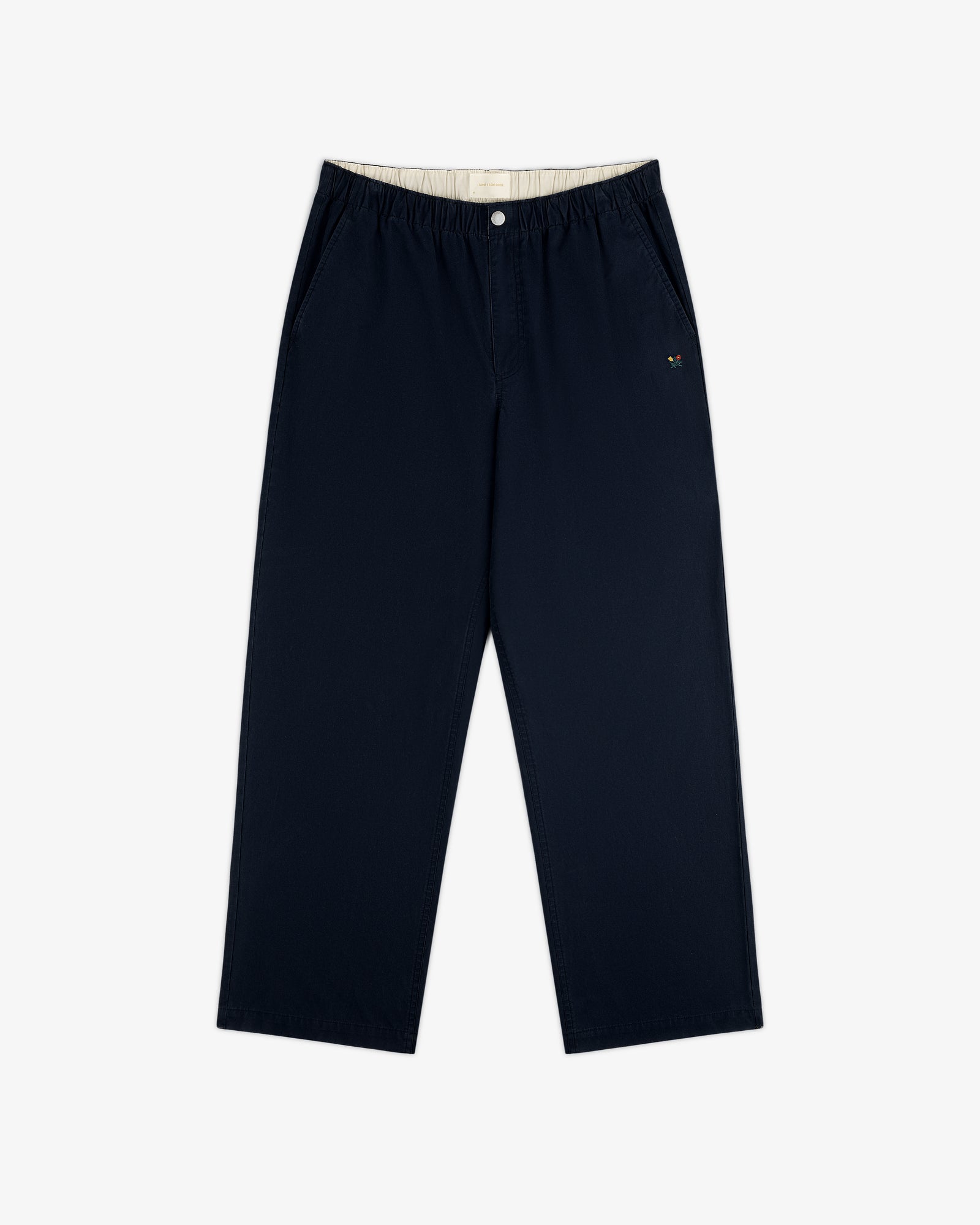 Washed Cotton Windbreaker Pant in navy blue features wide legs, elastic waistband, and small logo on left pocket.