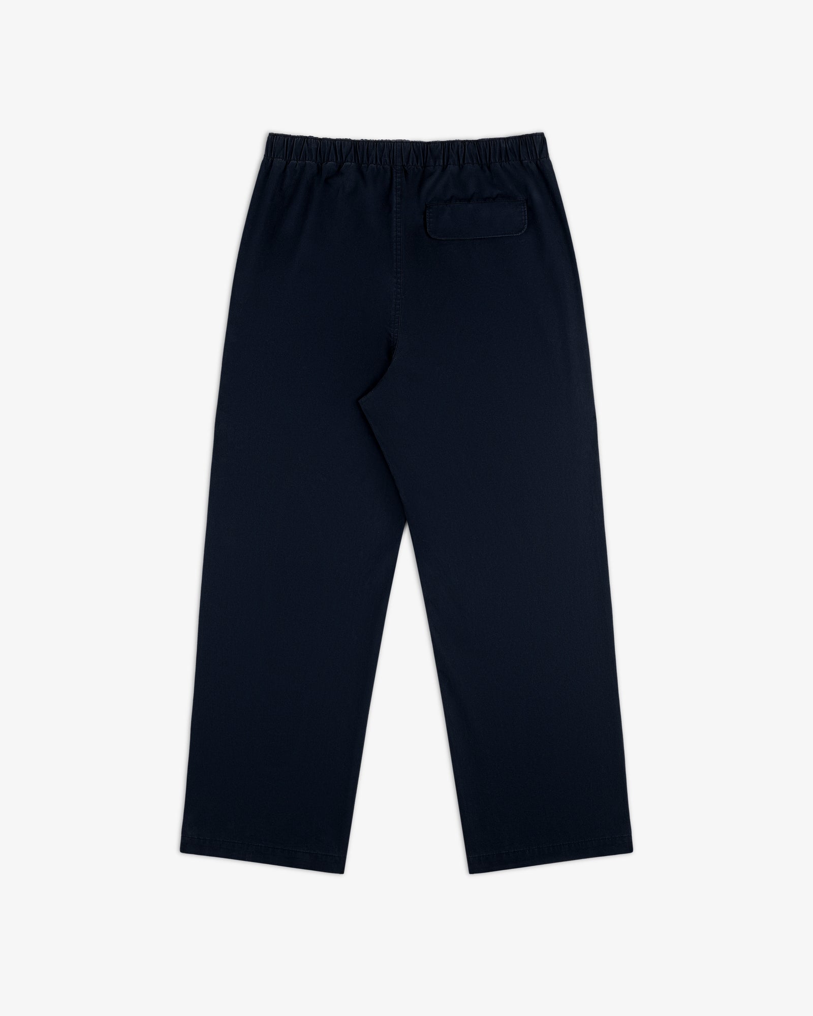 Washed Cotton Windbreaker Pant in navy blue with elastic waistband and single back pocket, shown on white background.