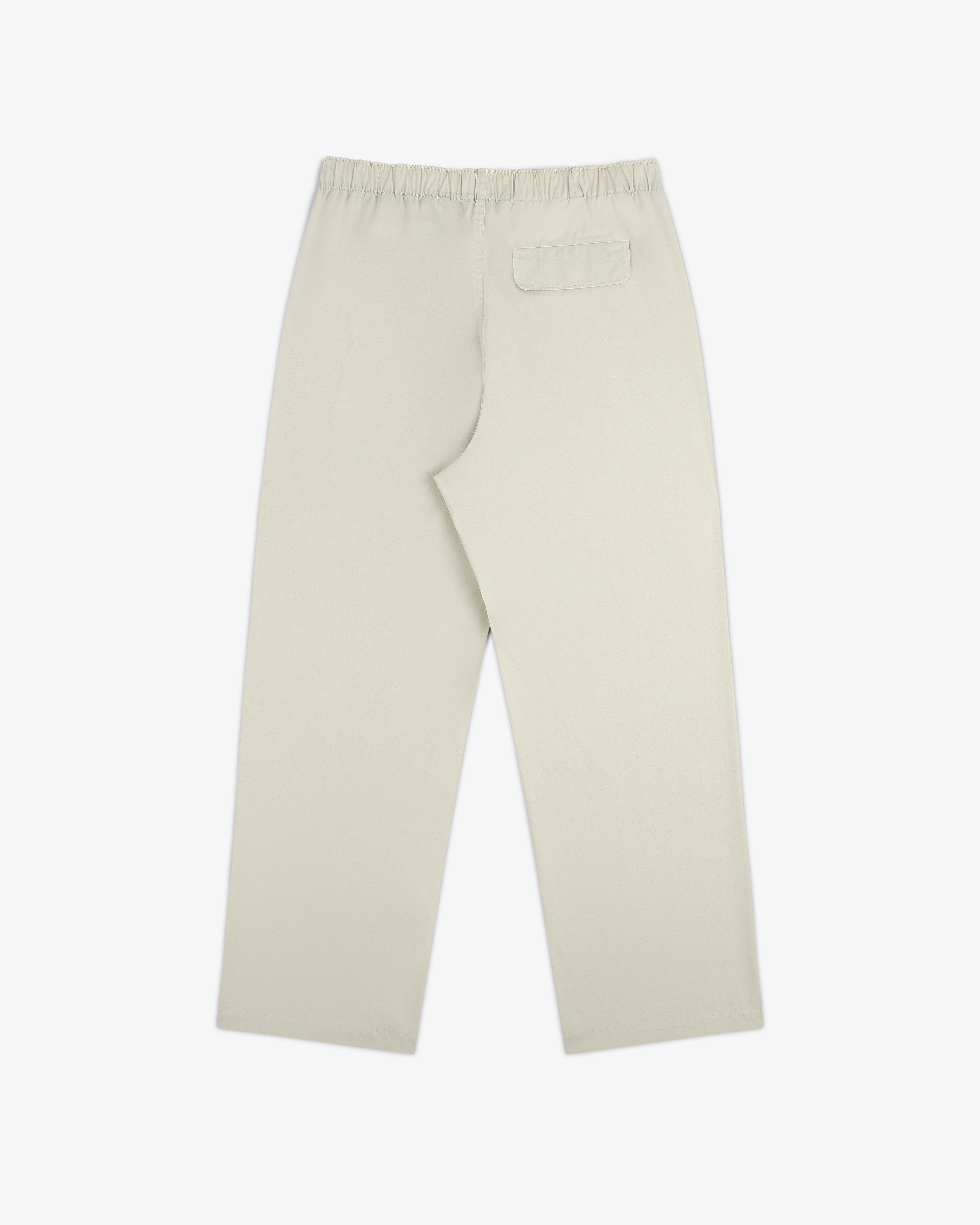 Washed Cotton Windbreaker Pant in beige, straight-leg with elastic waistband and single back pocket, shown flat.