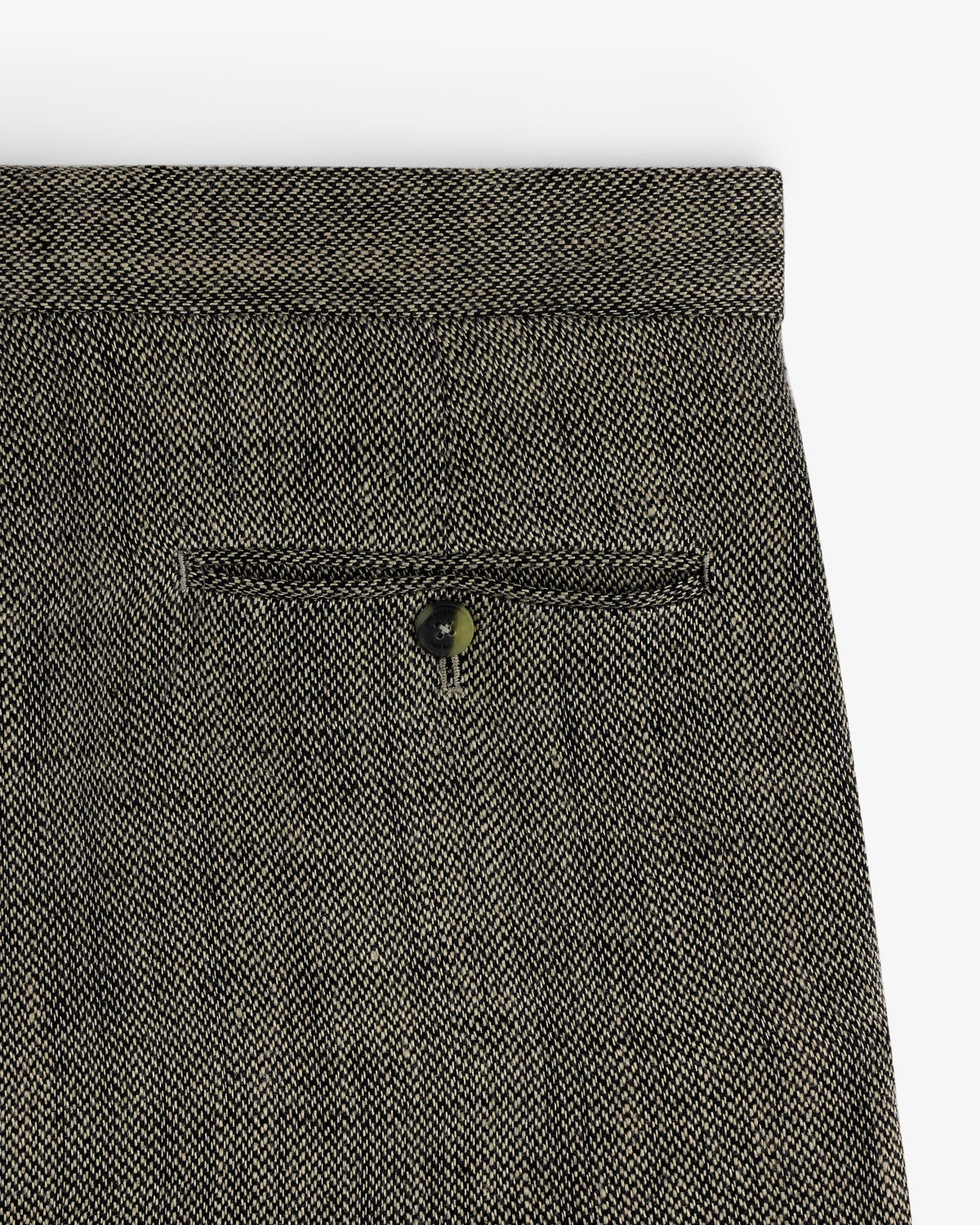 Close-up of the back pocket on Yarn Dyed Linen Suit Trouser in gray with a single button closure.